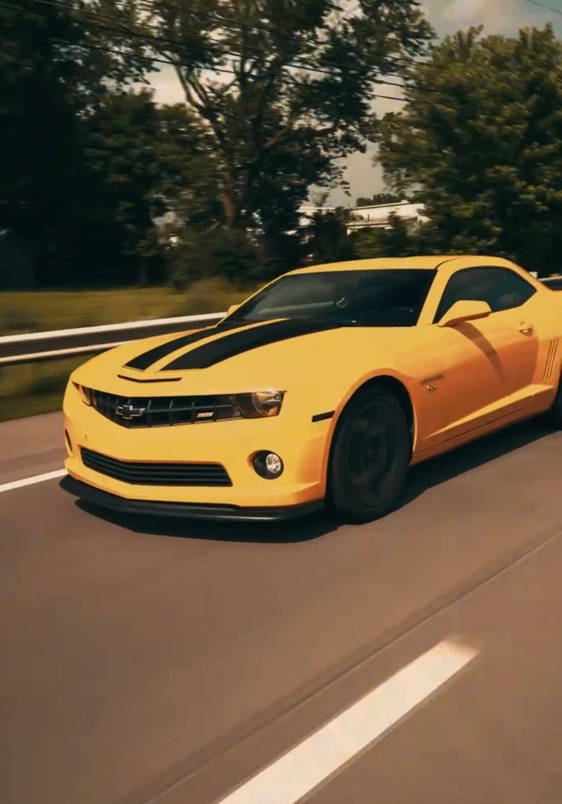 A yellow Camaro on the highway