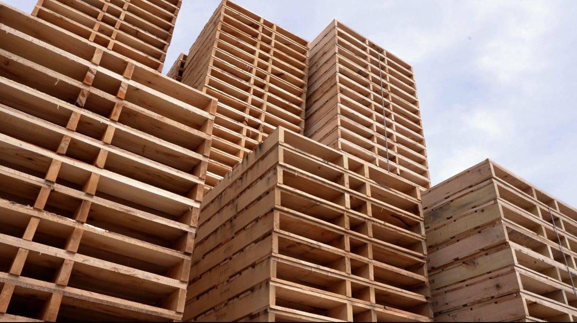 Pallets in tall stacks outside