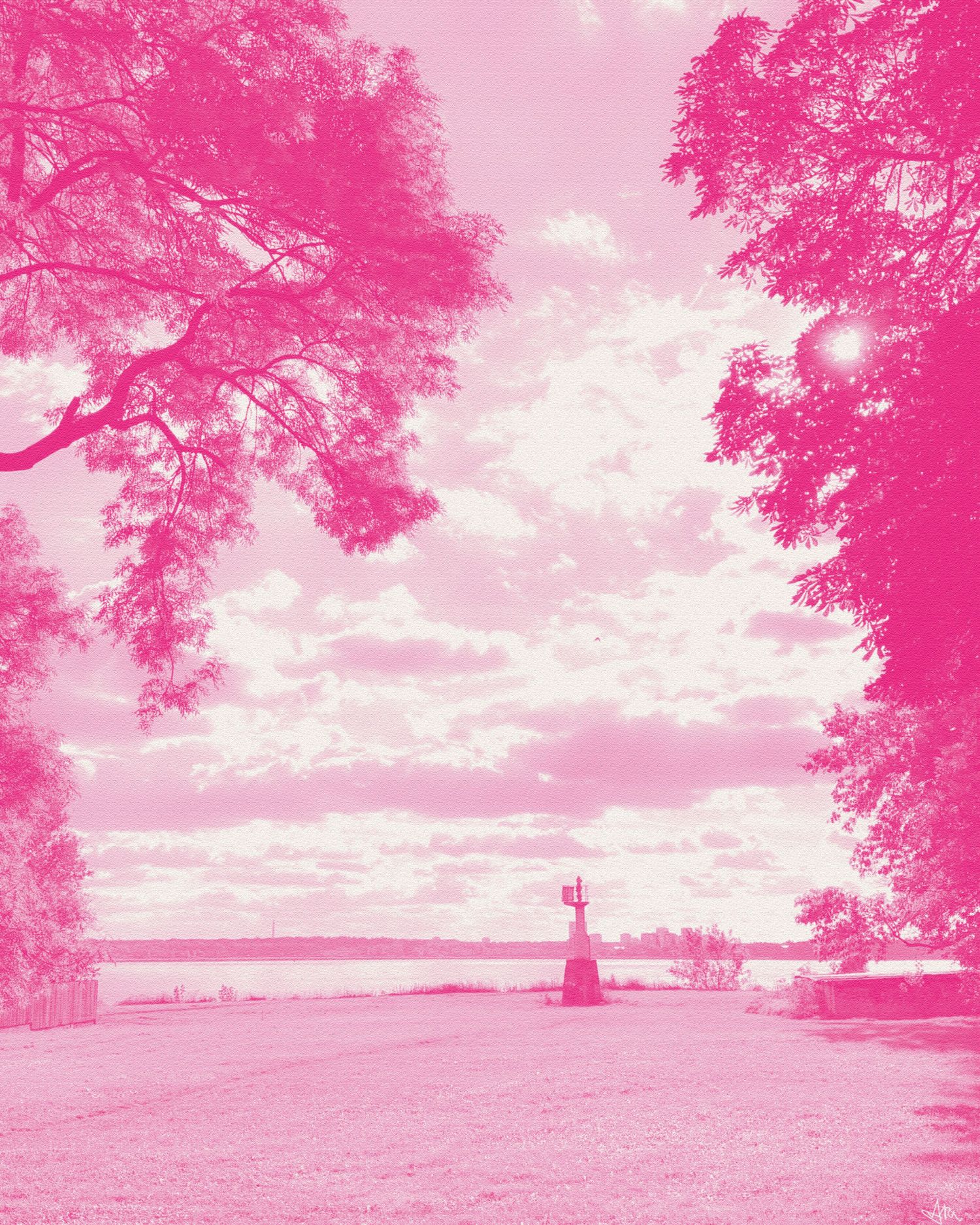 Pink-tinted infrared photo of a park with tall trees, a statue, and a calm waterfront under a cloudy sky.