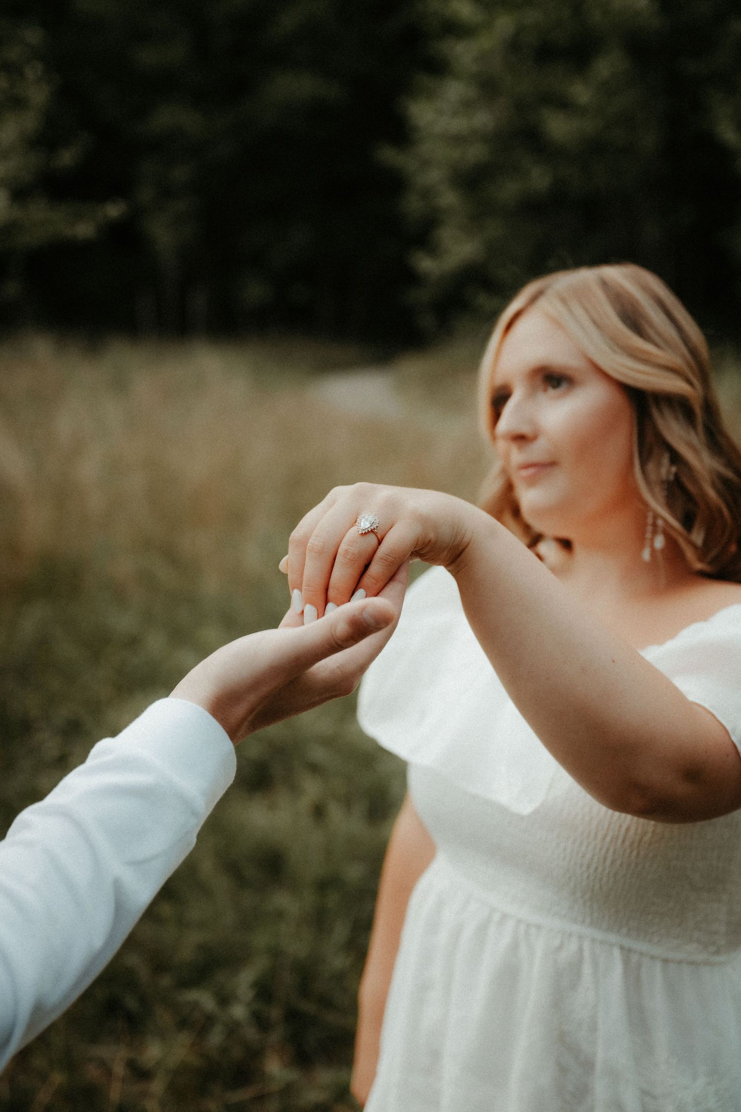 Close up of couple's hands during intimate wedding moment as ring is worn in outdoor natural setting. Pittsburgh Wedding Photographer