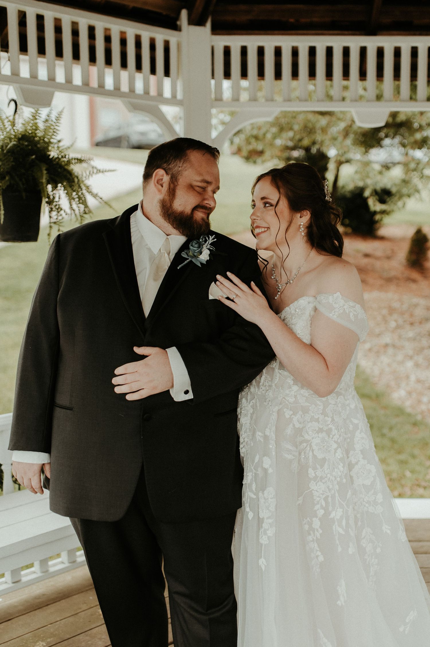 A couple shares an intimate moment on a white gazebo during their wedding celebration. Pittsburgh Wedding Photographer