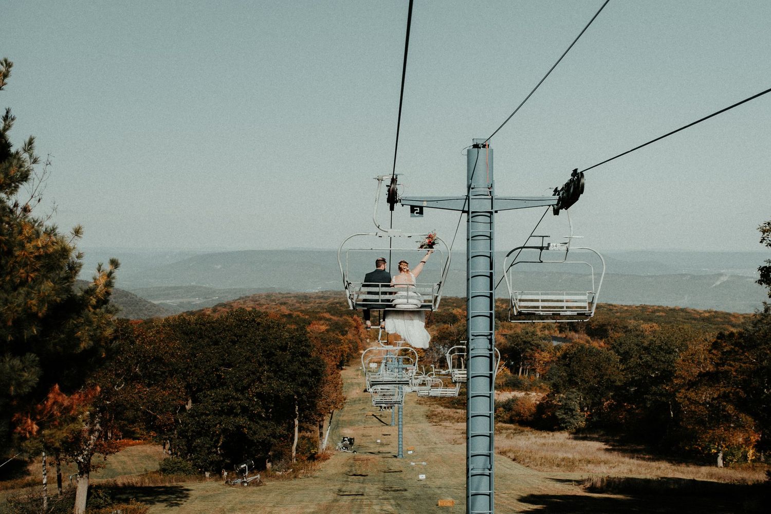 Ski lift chairs against mountain landscape during off-season. Pittsburgh Wedding Photographer