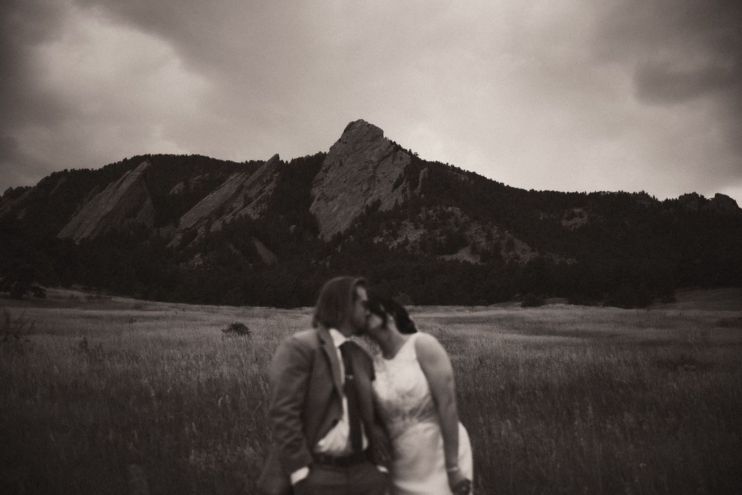 Black and white photo showing mountain landscapes and romantic couple moments in a rustic outdoor setting. Travel Elopement Photographer.
