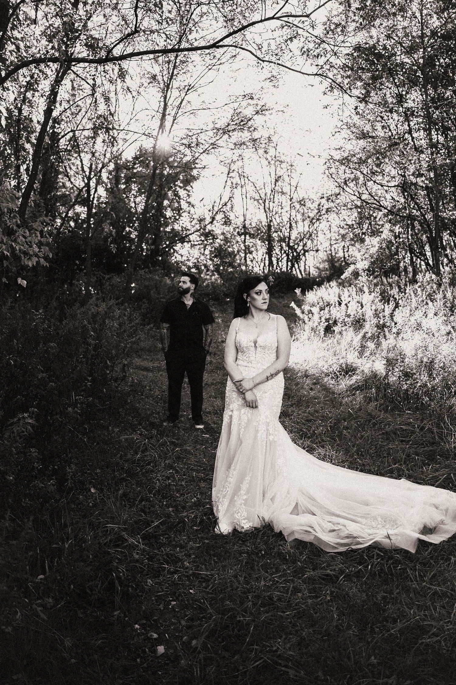 A romantic wedding photo of a couple in a wooded setting with a flowing white dress. Pittsburgh Wedding Photographer