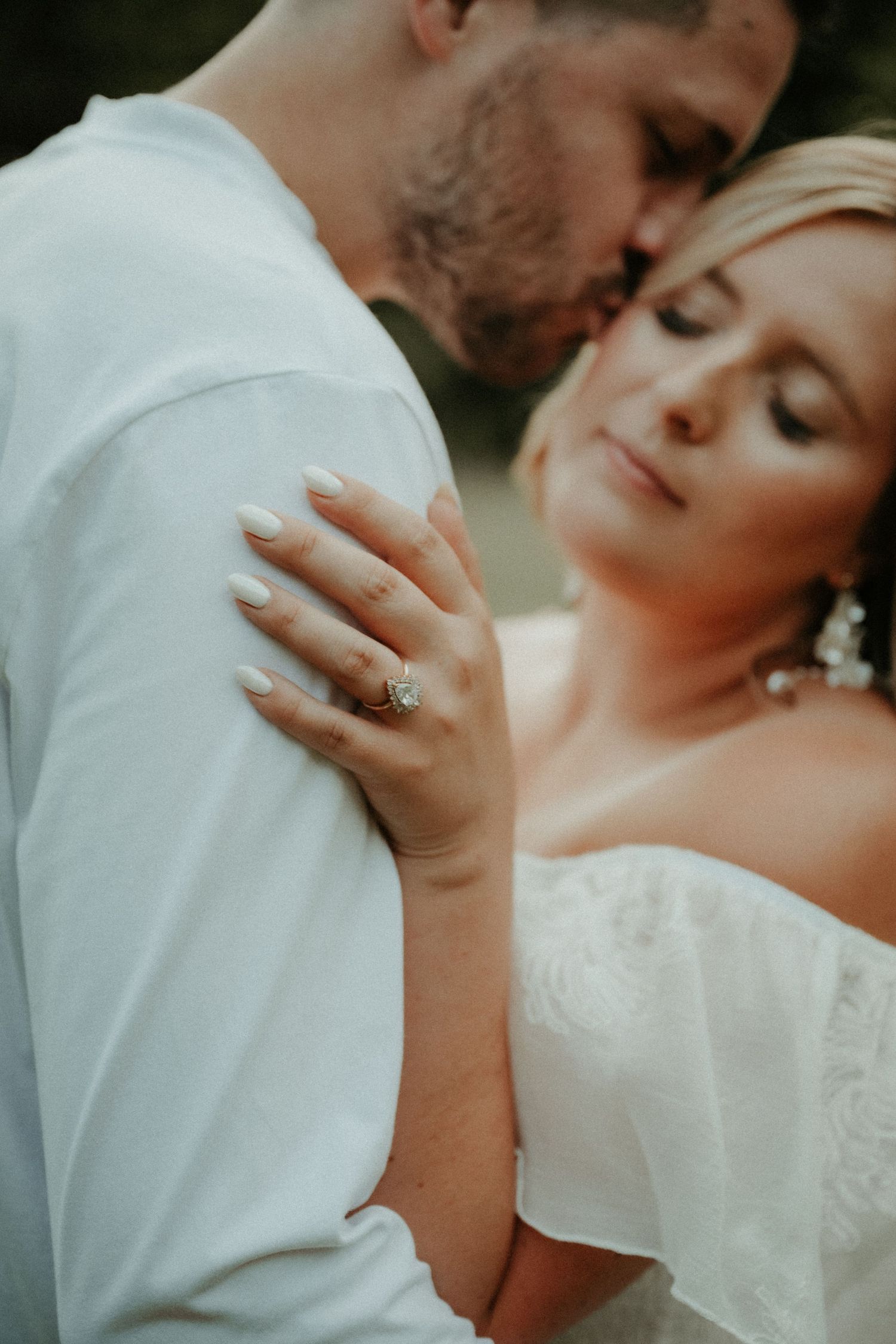A romantic close-up photo of a couple shows a tender moment with her hand resting on his chest. Pittsburgh Wedding Photographer