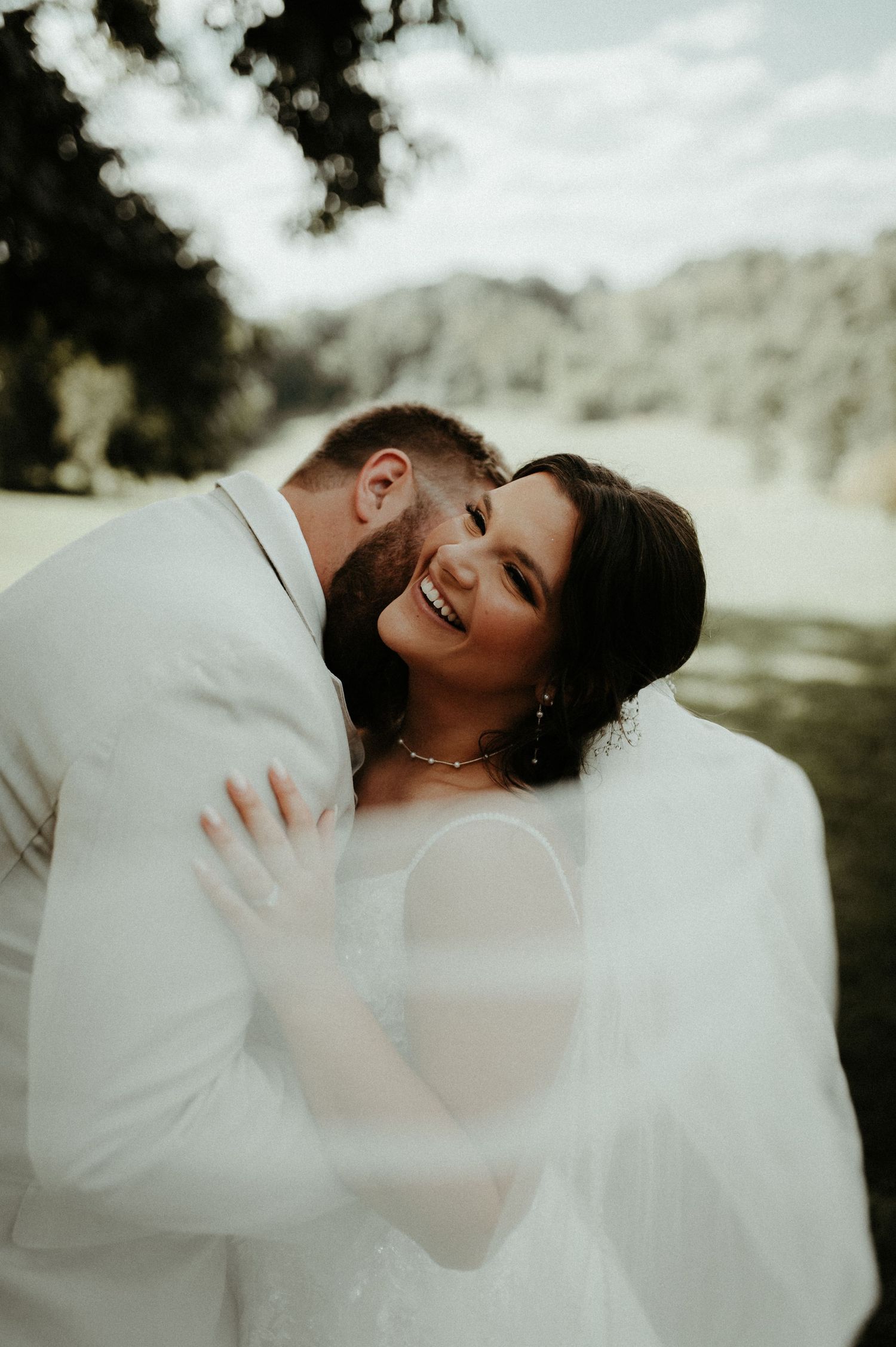 A joyful moment captured between newlyweds laughing together during their outdoor wedding photoshoot. Pittsburgh Wedding Photographer