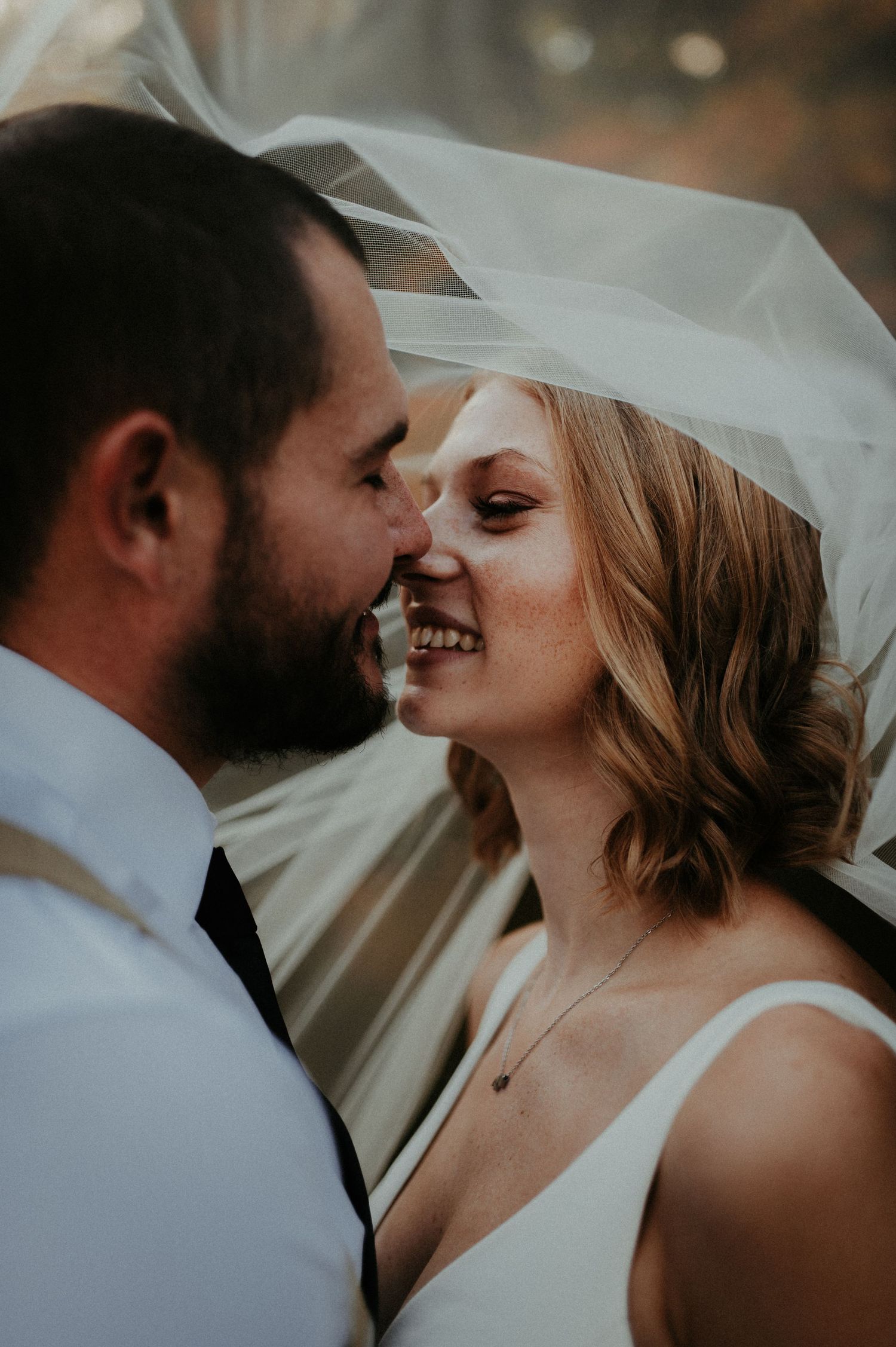 Intimate wedding portrait under flowing veil with soft natural lighting. Pittsburgh Wedding Photographer