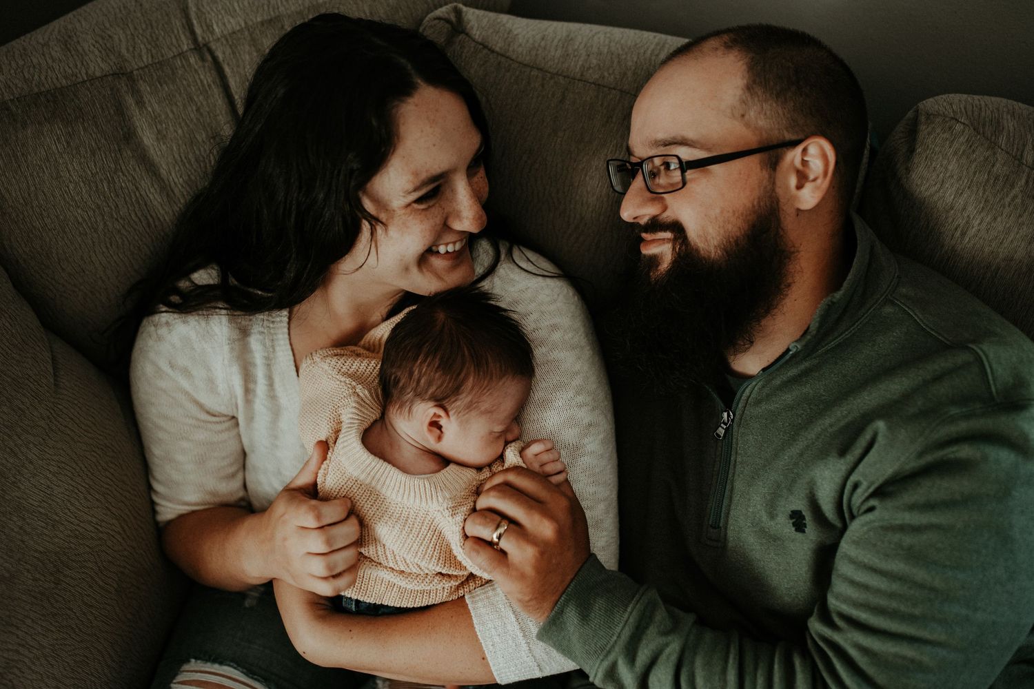 An intimate family moment shared on a cozy couch.