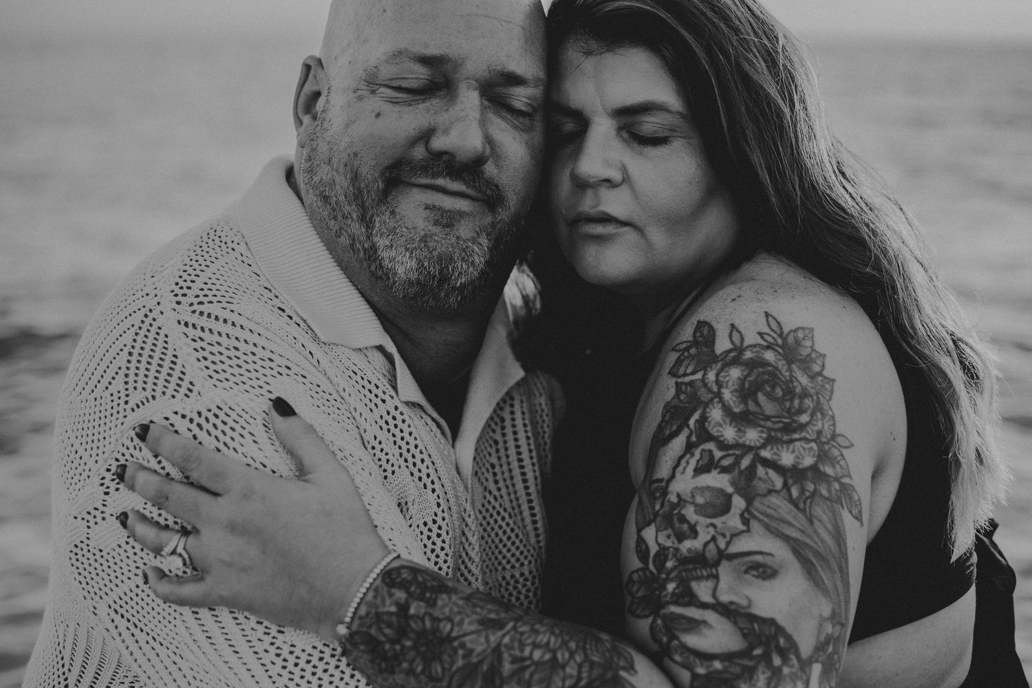 A romantic black and white photo series showing tender moments between a couple embracing outdoors.