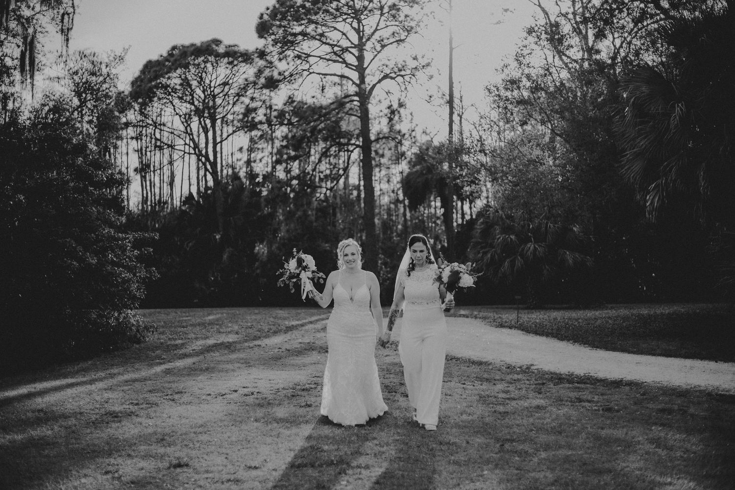 A series of black and white wedding photos showing a couple walking through a tree-lined outdoor setting.