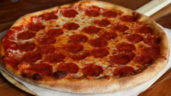 A series of pepperoni pizzas with melted cheese and crispy crust arranged in a row showing different angles.