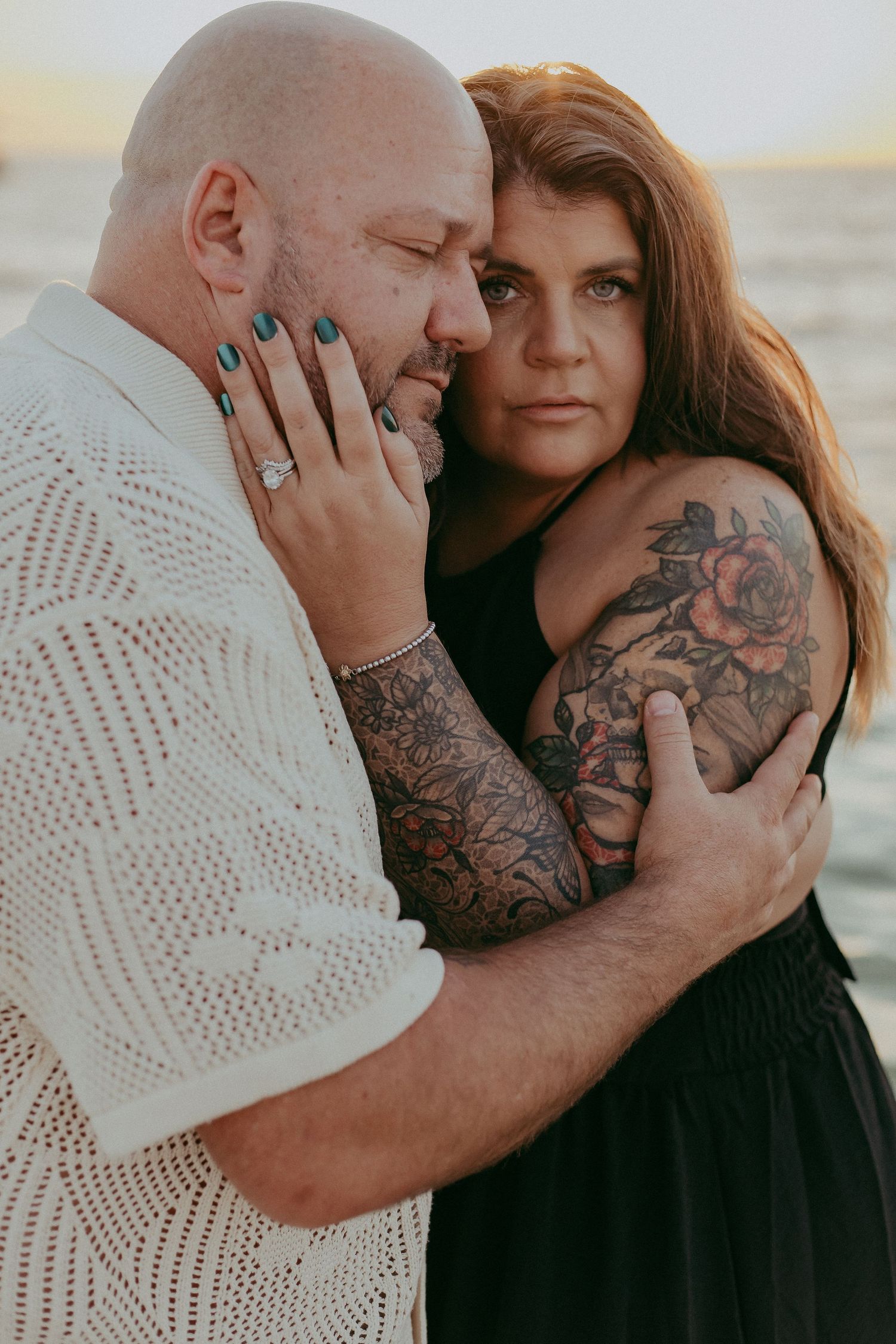 A couple shares an intimate embrace on the beach in a series of romantic sunset photos.