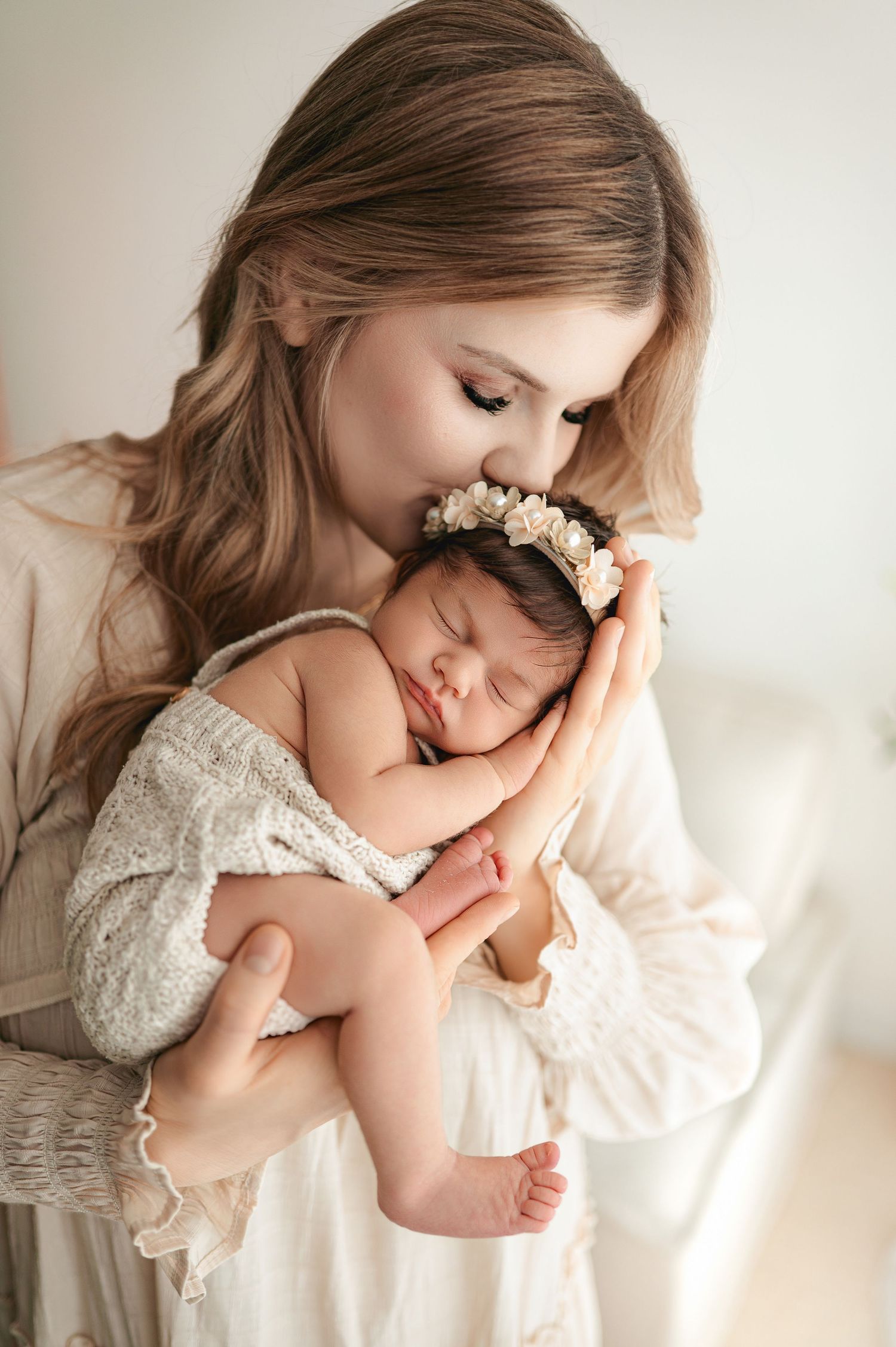 A tender series of photos shows loving embraces in soft white tones and neutral studio lighting.