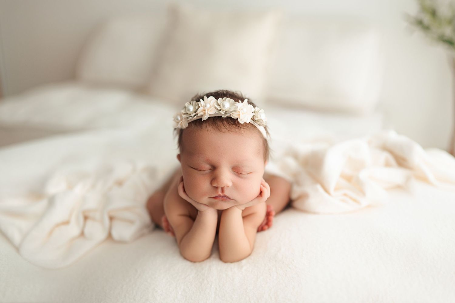 Pink and white newborn photography collage with a baby sleeping in soft blankets and springtime tones.