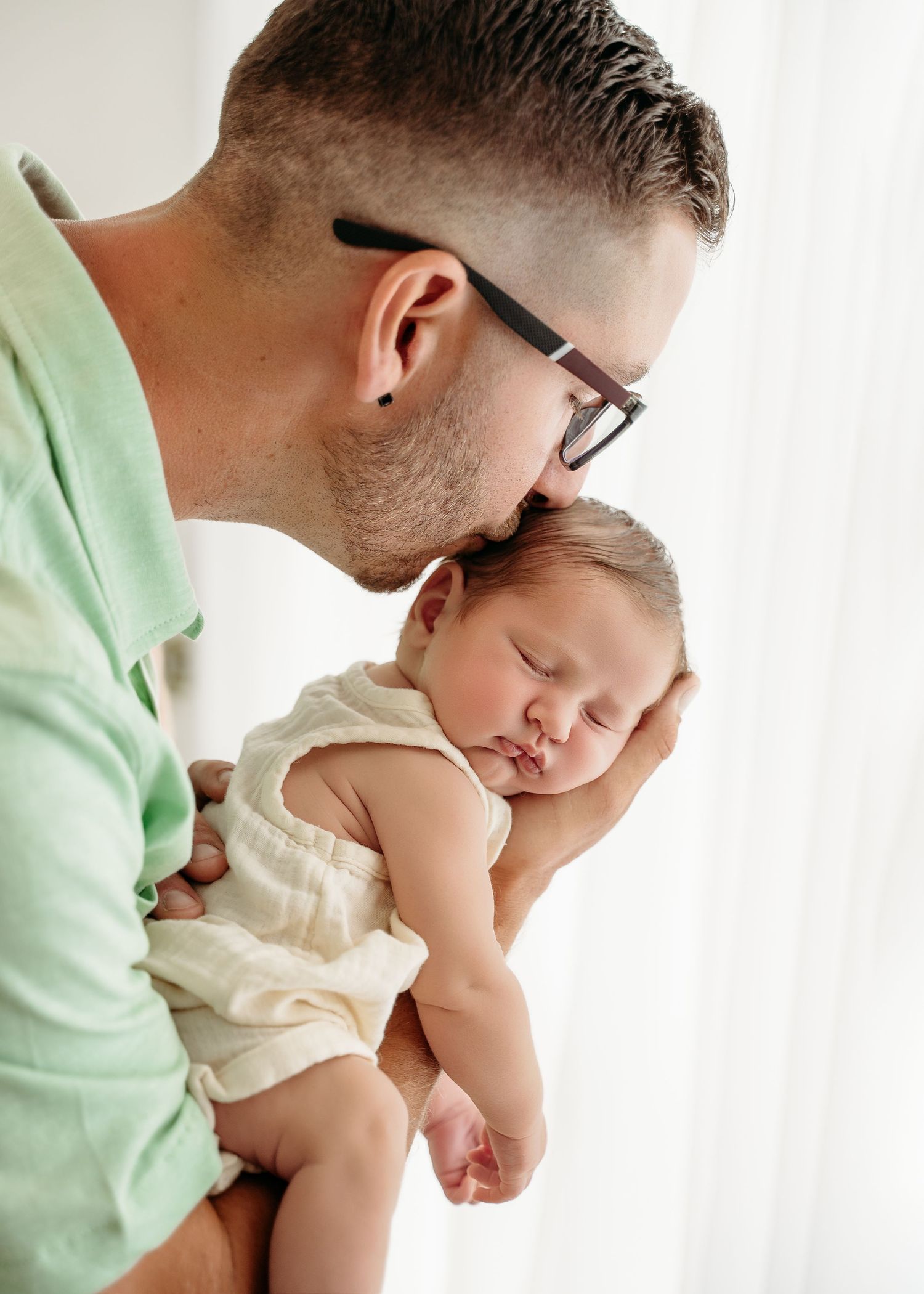 A tender moment between parent and baby sleeping against a white background shown in multiple sequential views.