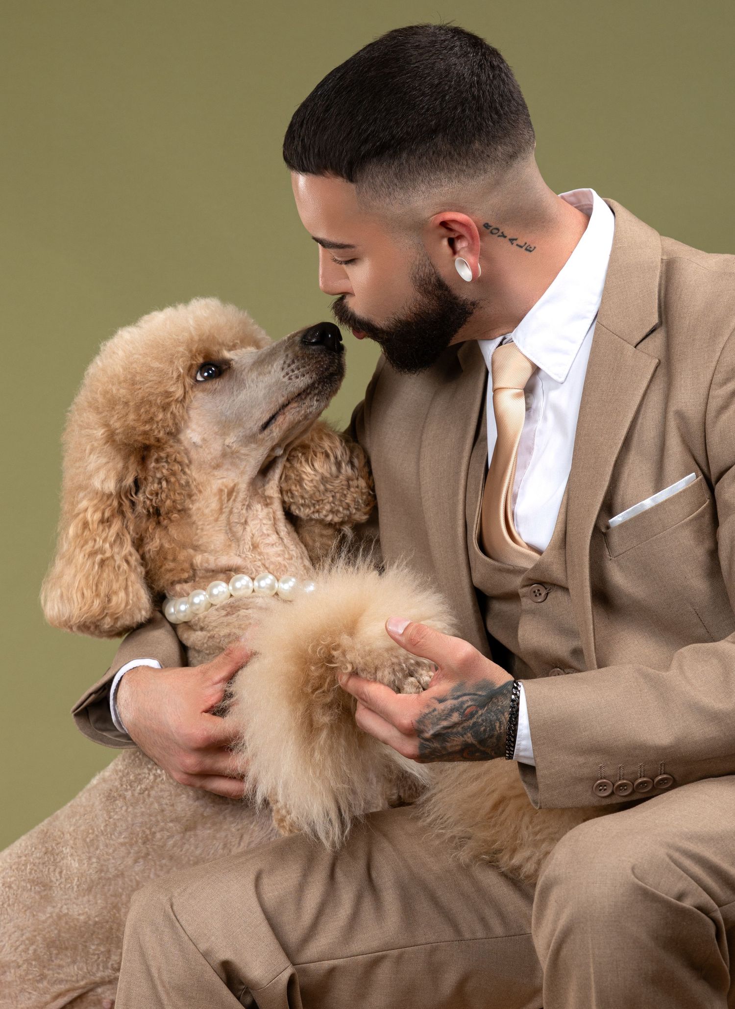 A person in a tan suit lovingly embraces a fluffy apricot-colored poodle in a series of heartwarming poses.