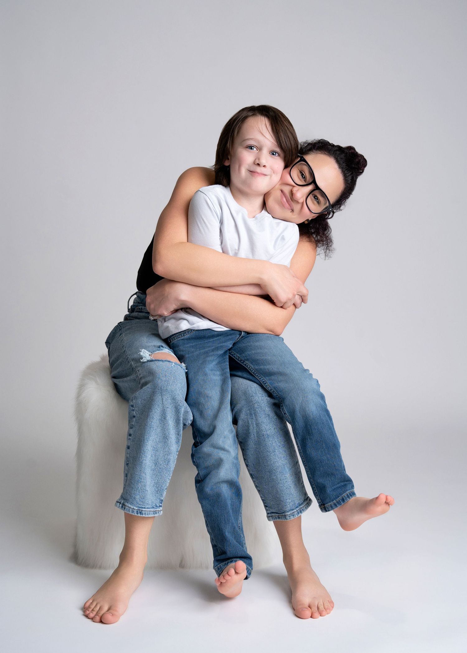 a mother hugs her son during a session with a motherhood photographer