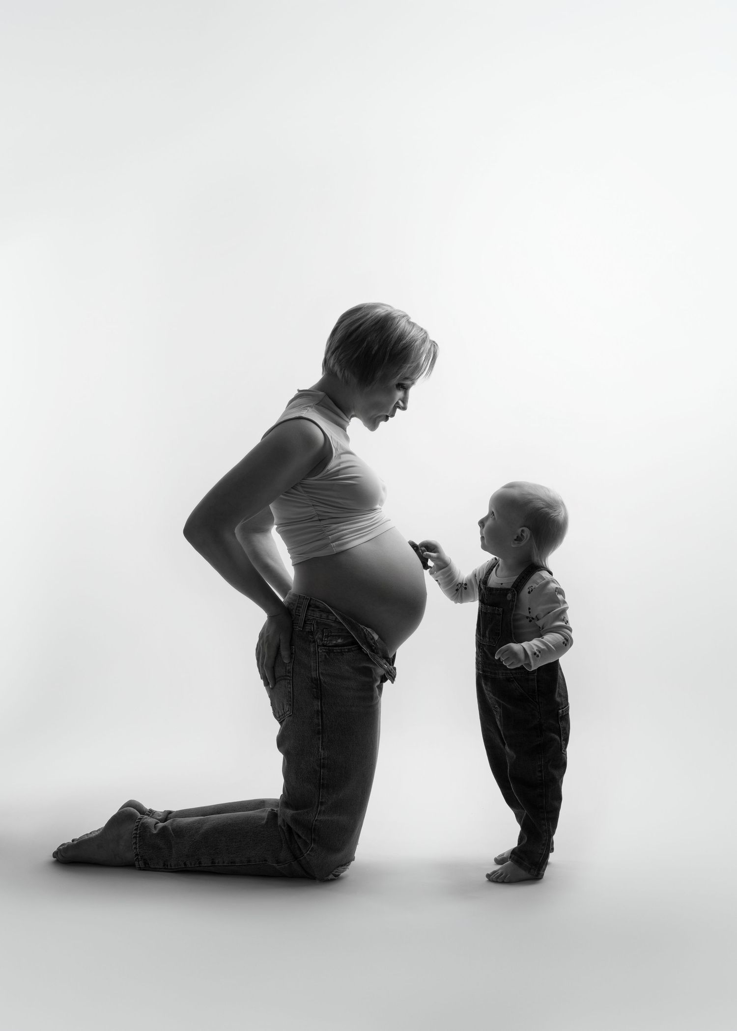 a mother kneels next to her child
