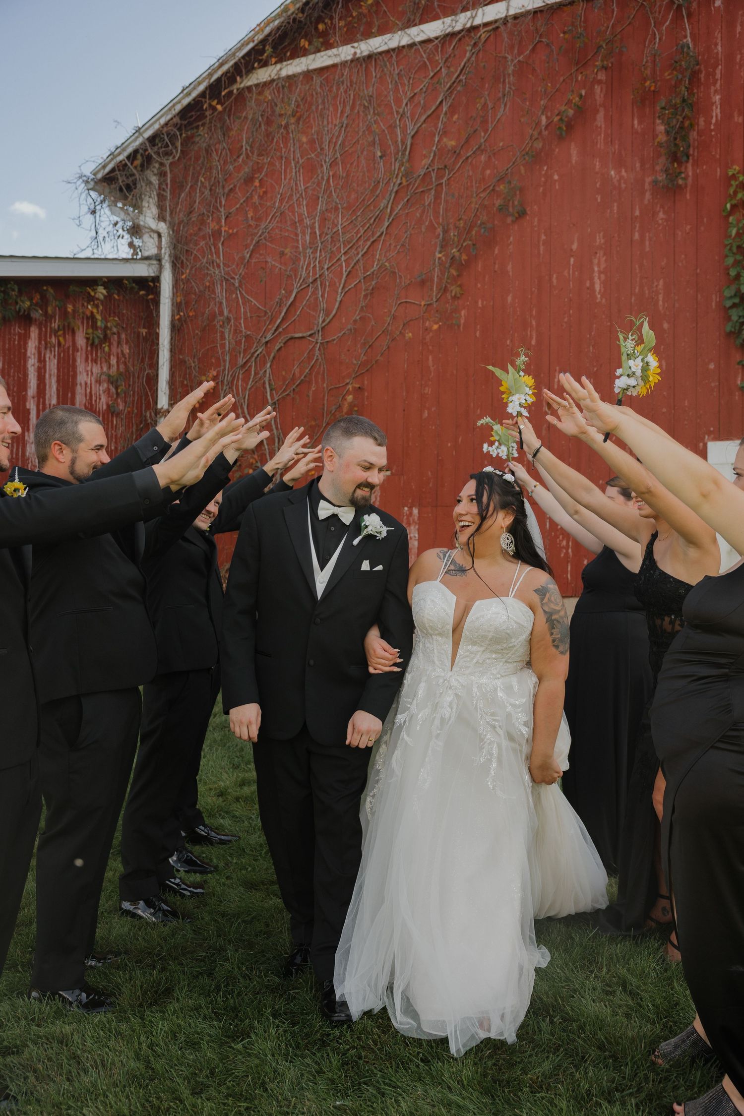 Wedding party in formal attire poses playfully against rustic red barn backdrop in sequence of candid celebration shots.