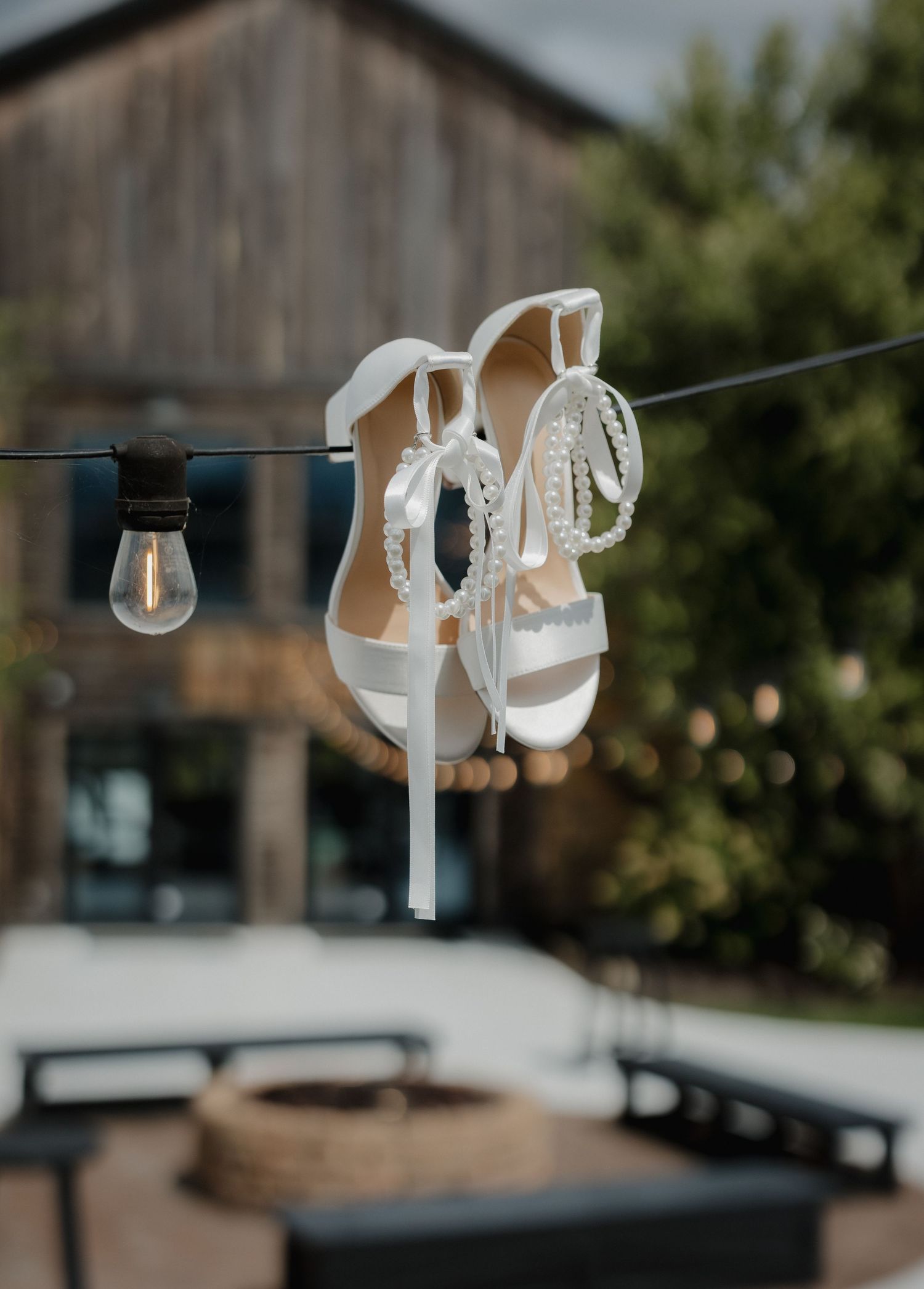 String lights hang elegantly across an outdoor wedding venue creating a romantic atmosphere.