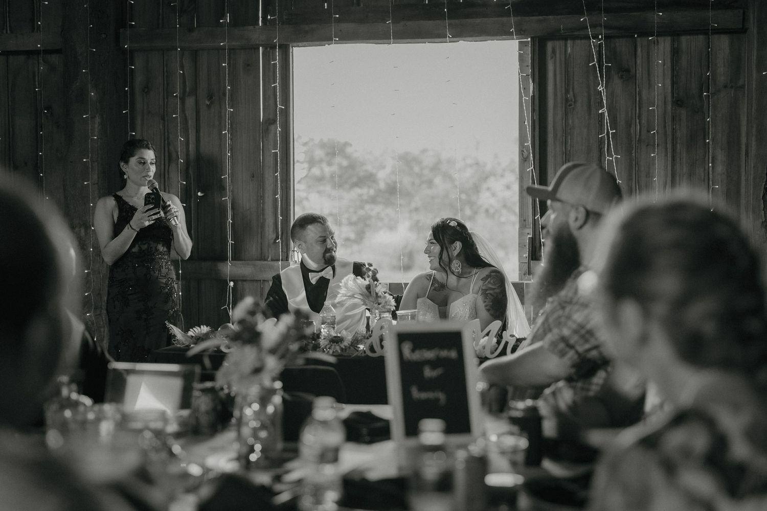 A collection of black and white photos showing people dining and socializing at a formal event.
