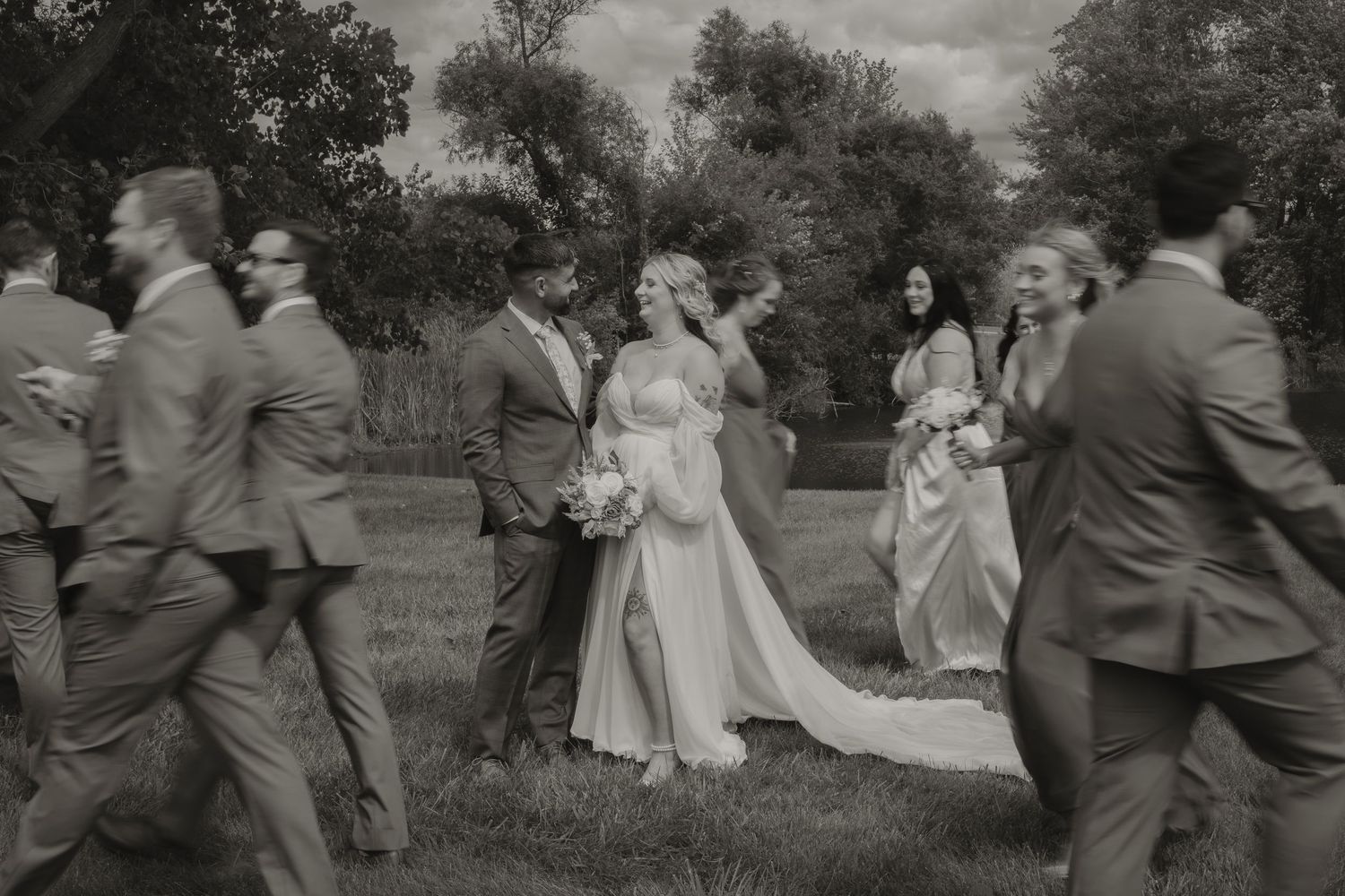 Wedding party celebrating and dancing together outdoors.
