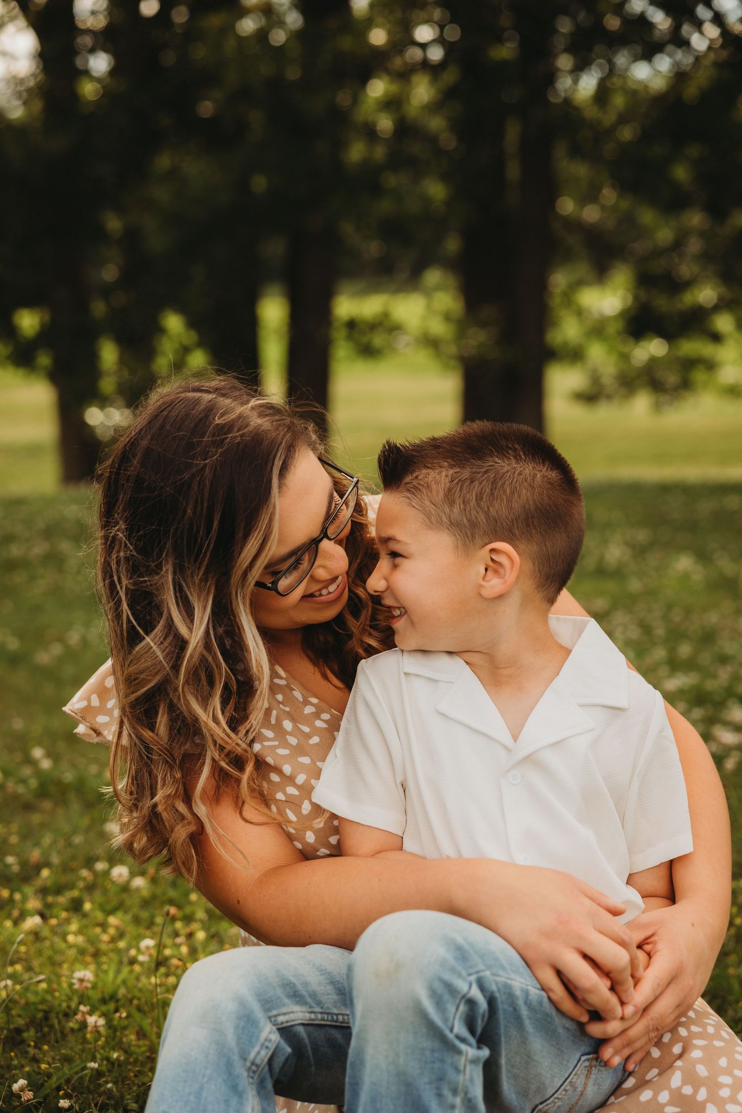 A tender outdoor portrait captured in dappled sunlight on a summer afternoon.