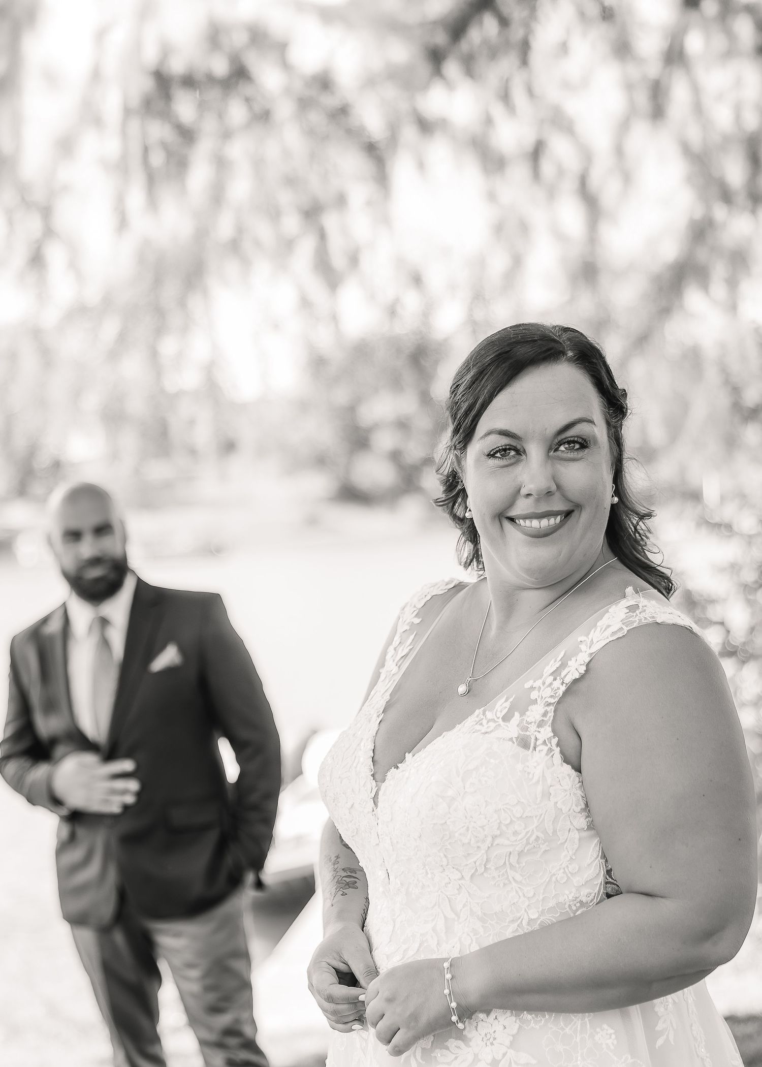 A series of black and white wedding photos showing candid moments between a bride and groom in an outdoor setting.