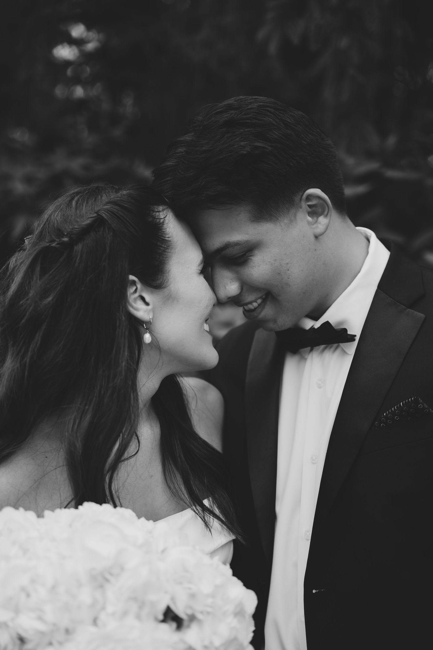 A romantic black and white wedding photo sequence showing a couple in formal attire sharing an intimate moment.