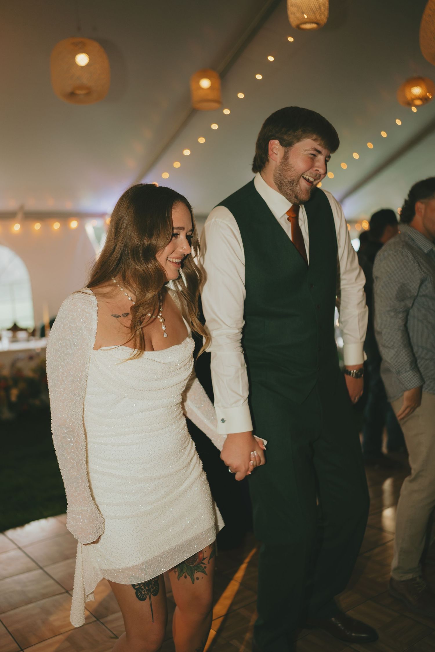 Wedding reception dance floor filled with couples enjoying a romantic evening celebration under warm lighting.
