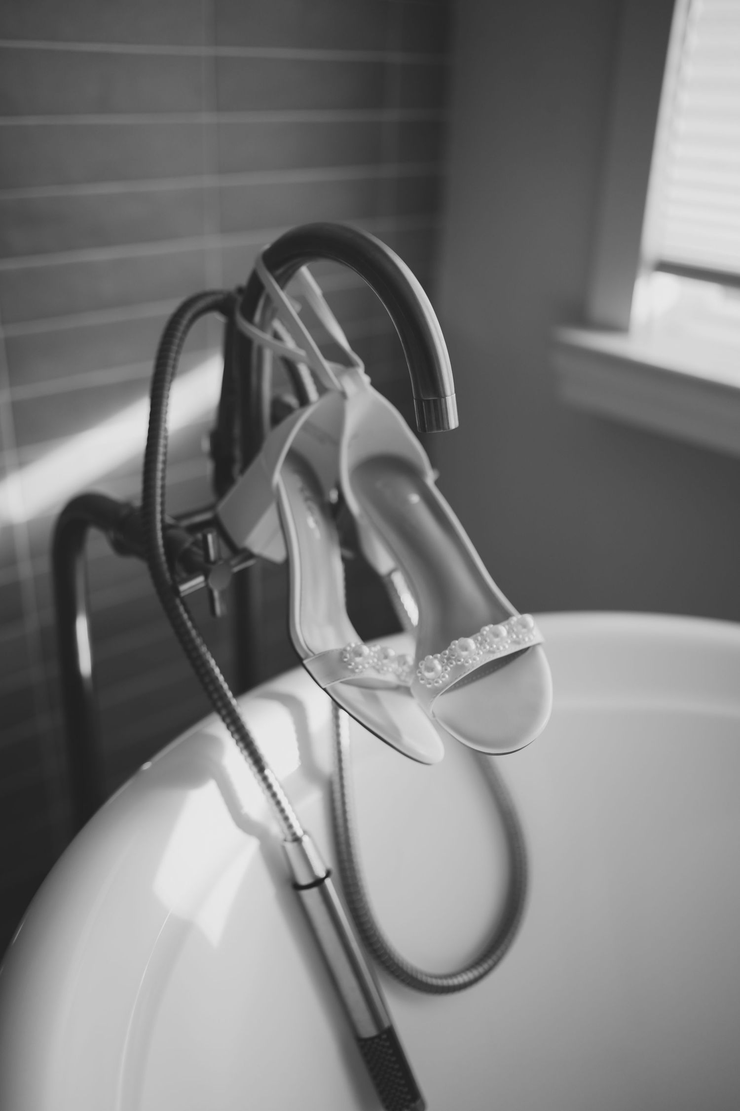 White vintage-style headphones rest on a clean surface in dramatic black and white lighting.