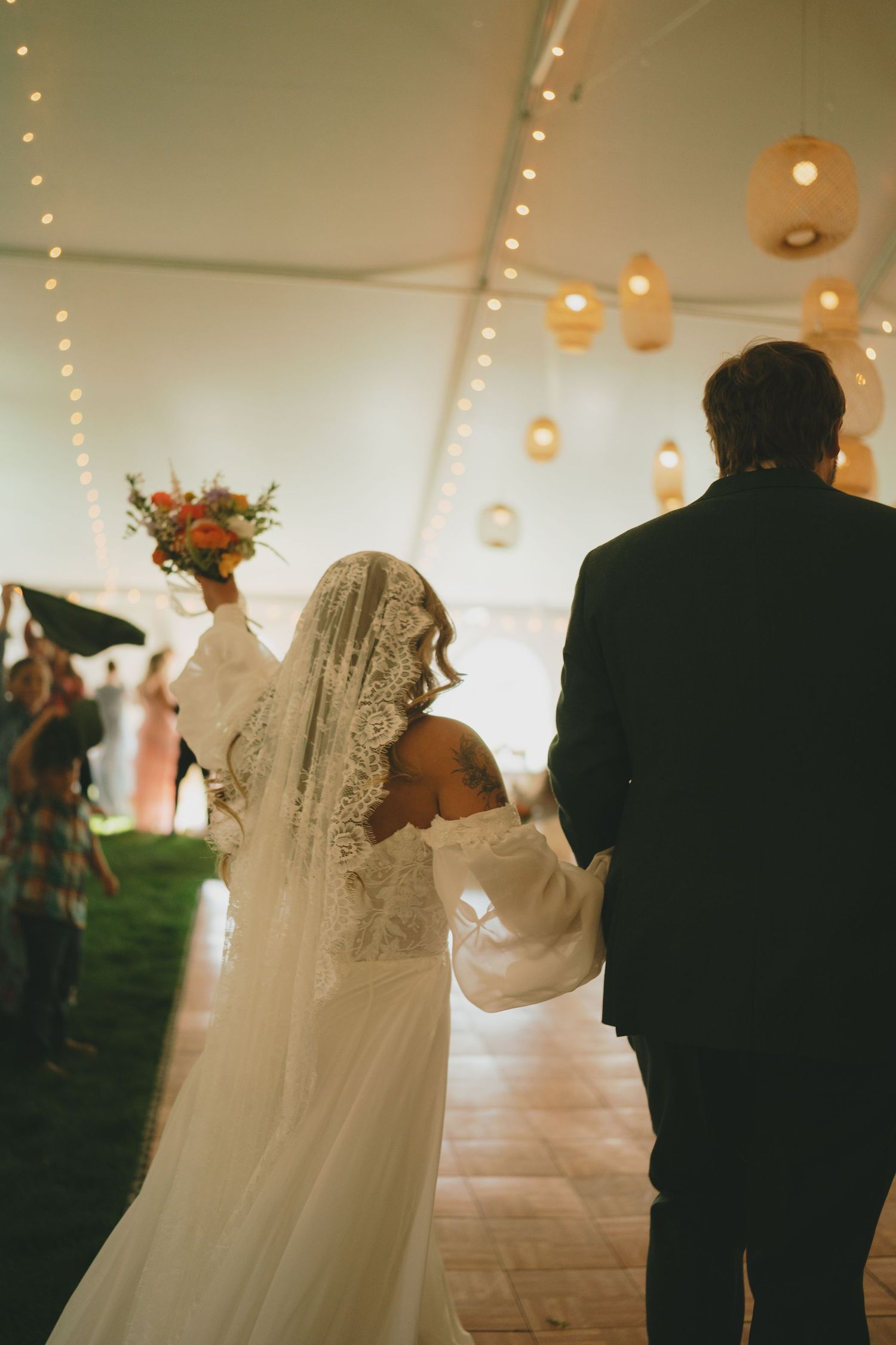 A sequence of dance photos at a wedding reception under string lights and white tent.