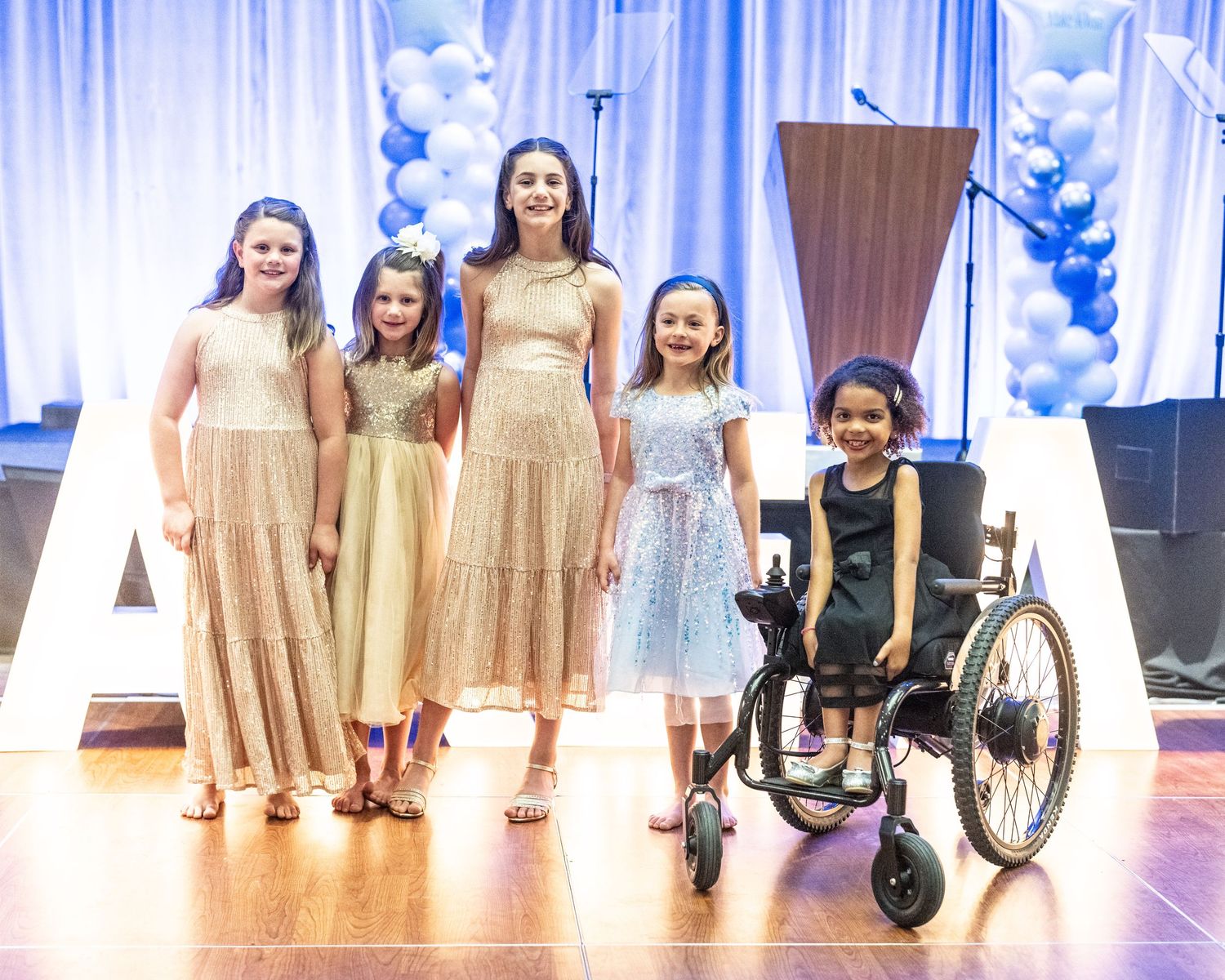 Five young girls pose together at the Big Wish Gala
