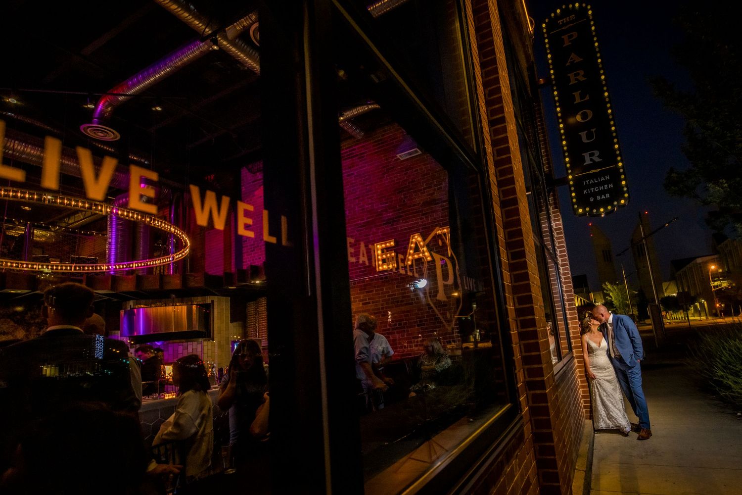 Nighttime urban wedding photos with colorful neon signs and city lights.