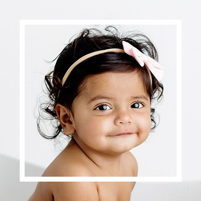 Professional photo by baby photographer in Menifee California; Cute 8 month old baby girl  smiling at camera.