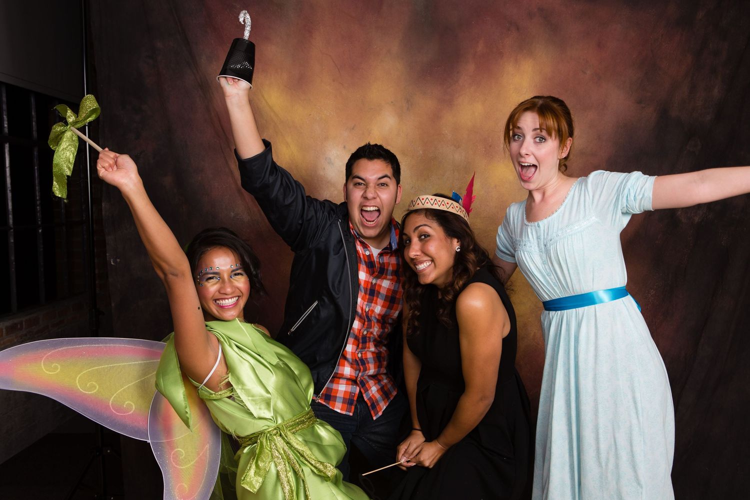 Four friends in costumes celebrating joyfully at the Gensler party