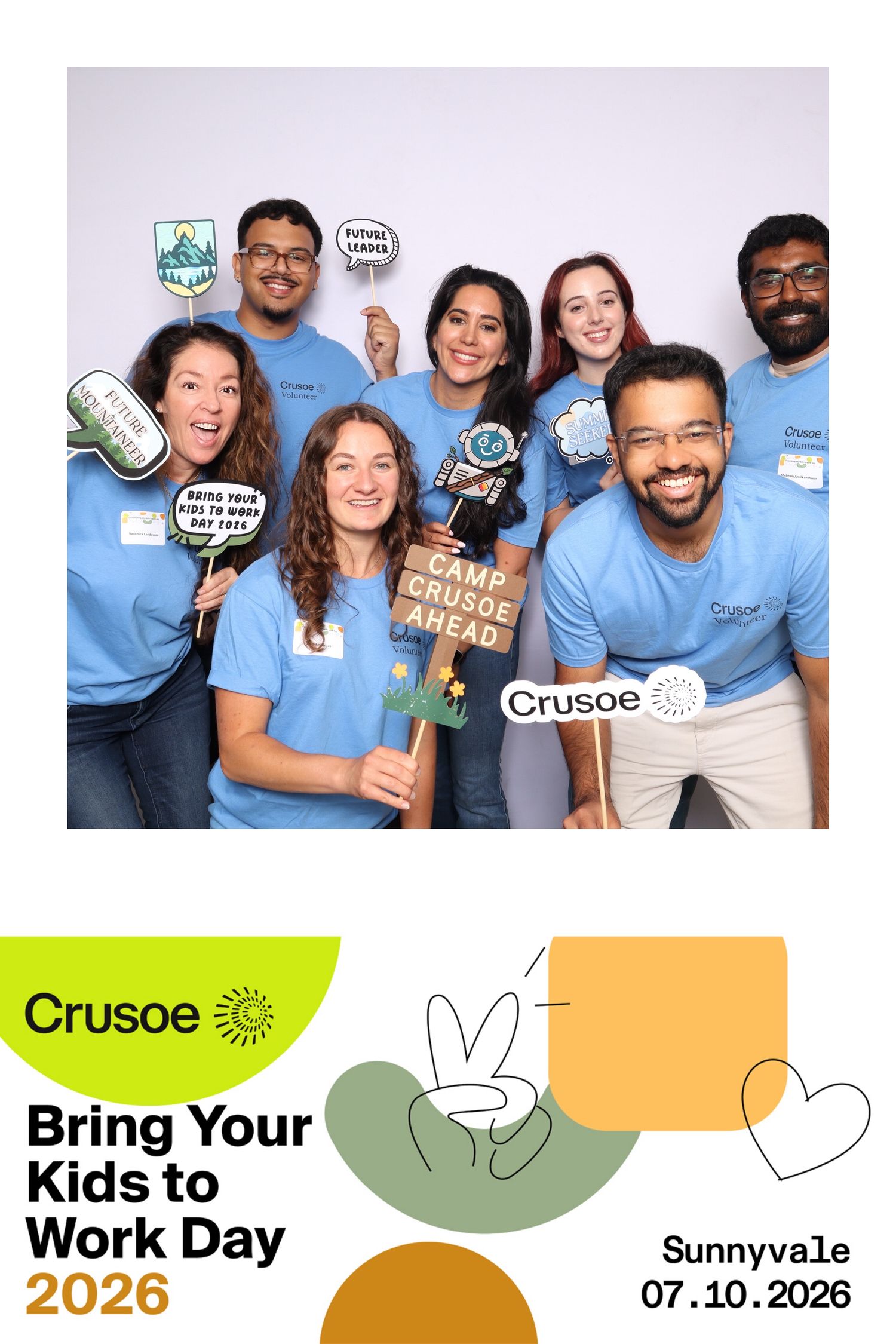 Group photo at Crusoe Bring Your Kids to Work Day 2026 in Sunnyvale, employees in blue shirts holding fun props.
