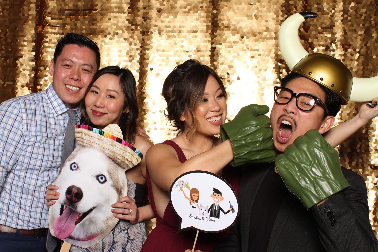 Wedding guests posing with props at a Snapbox Collective photo booth in Pleasanton, CA.