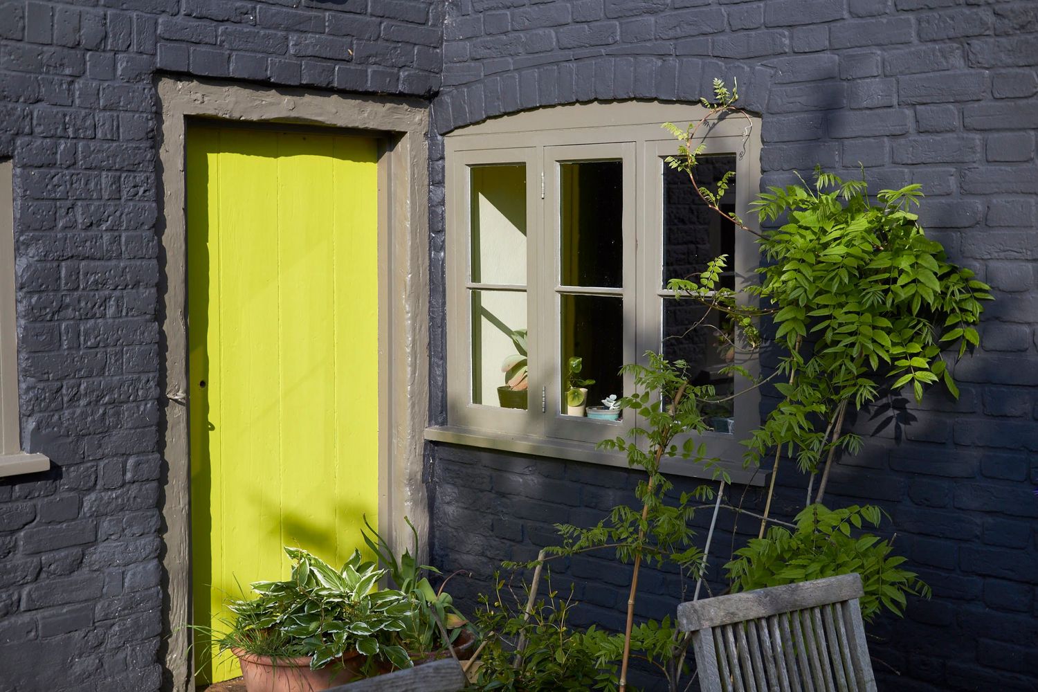 Bright yellow door exterior of the Old Forge Hacheston sunlight by Cat Heygate Photo