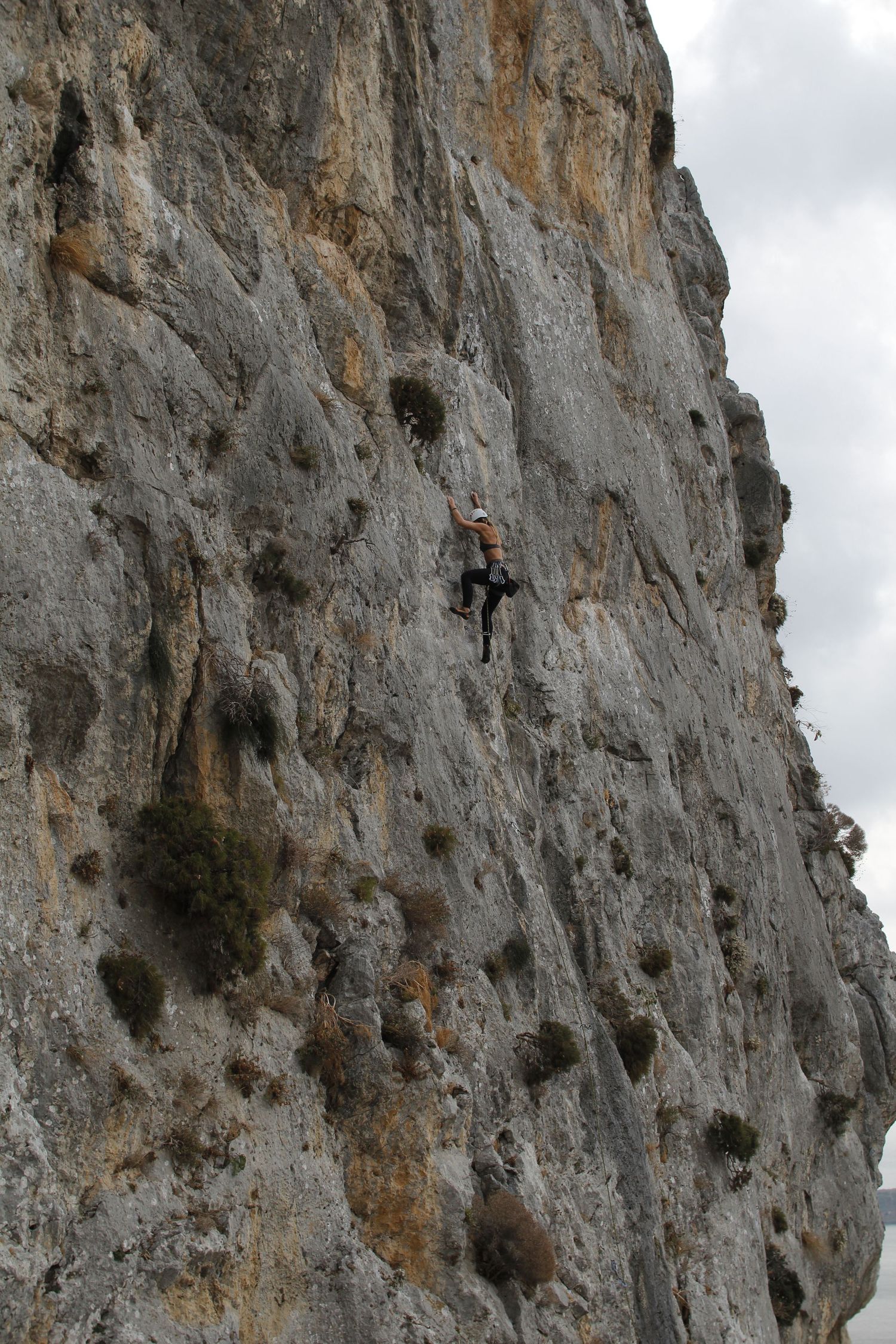Woman rock climbing in Greece