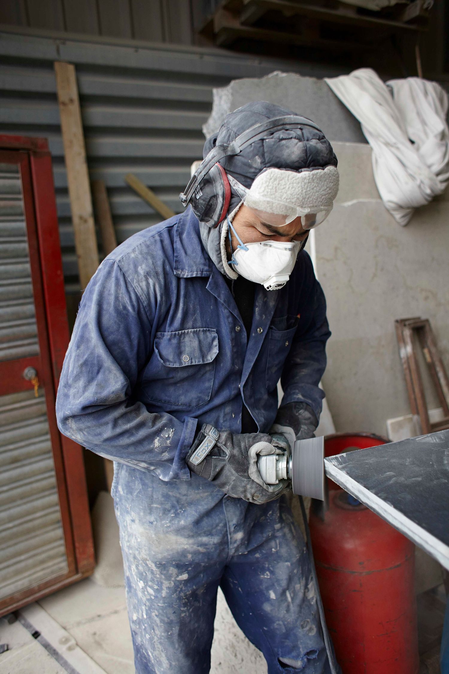 Suffolk stonemason sanding stone during a natural brand photoshoot