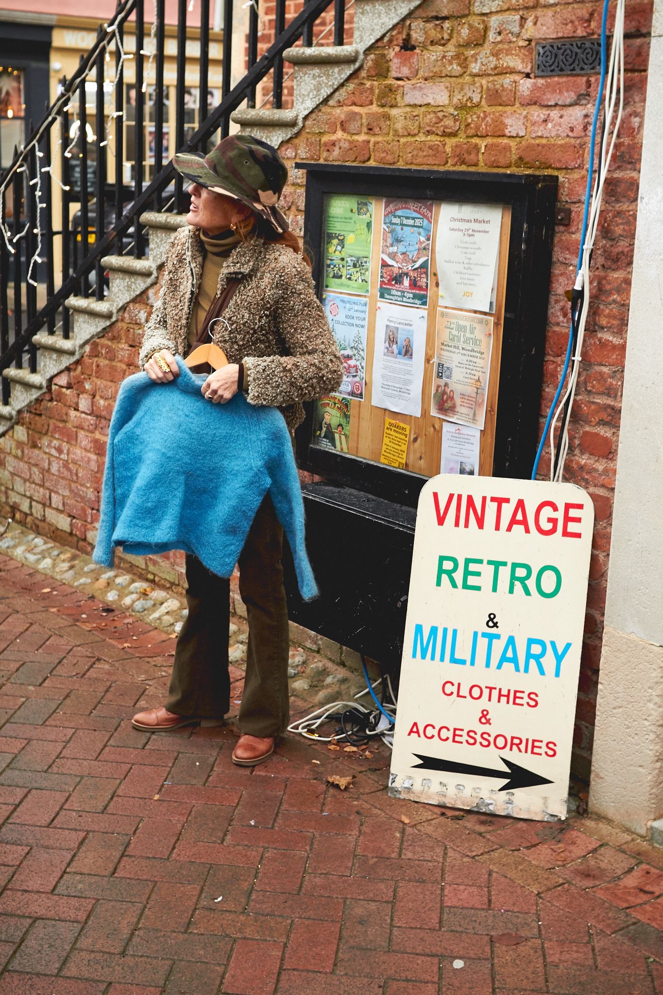 Woman holding a jumper at a vintage market in Woodbridge during a brand photoshoot