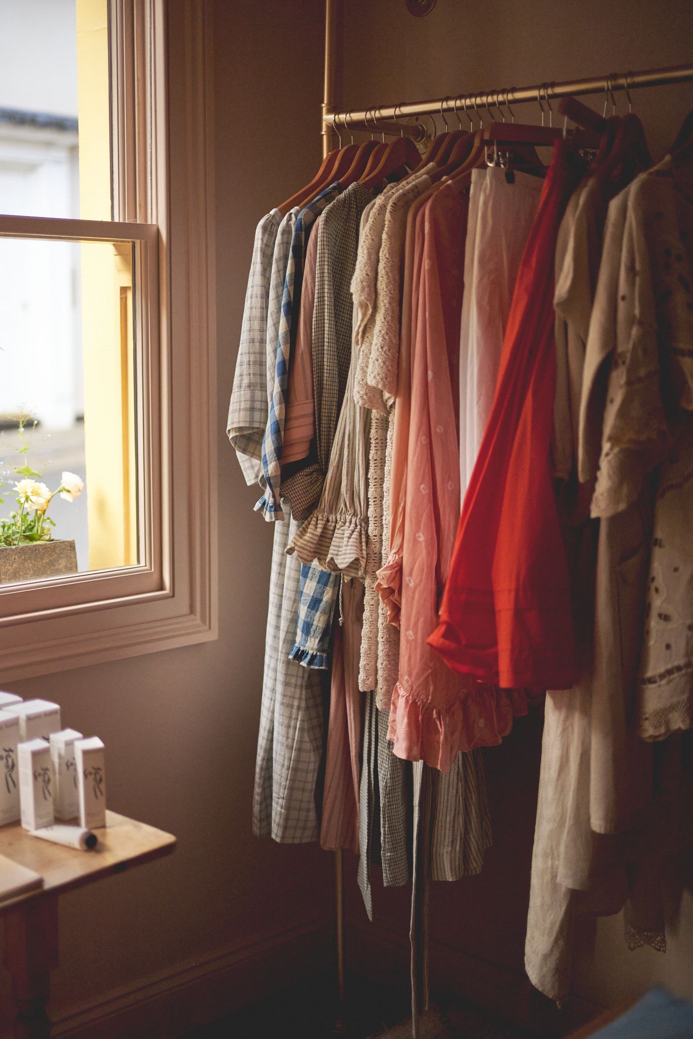 Clothes hanging in soft natural light for small clothes shop Woodbridge by photographer Cat Heygate Photo