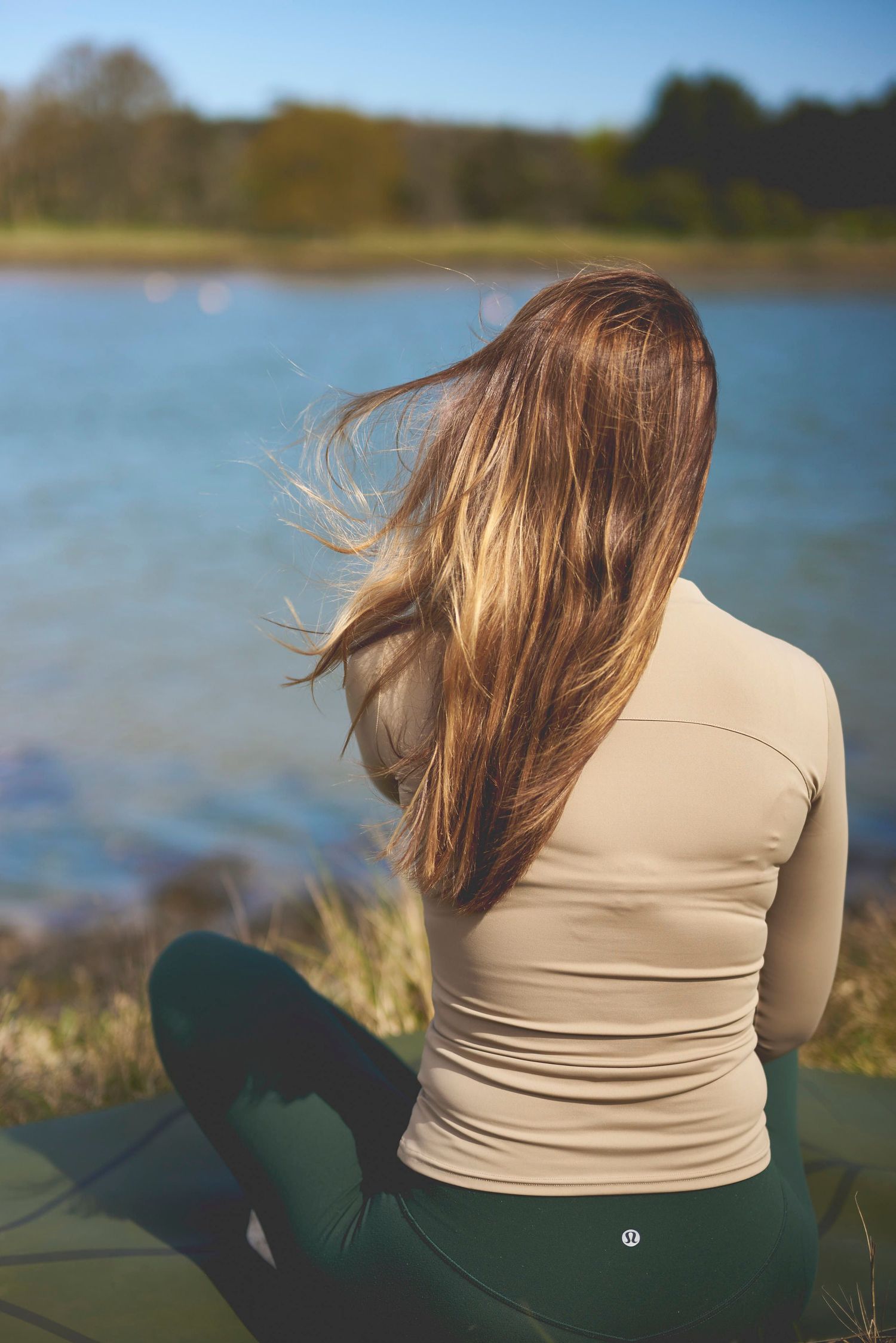Pilates instructor sitting outdoors in Woodbridge during a brand photoshoot