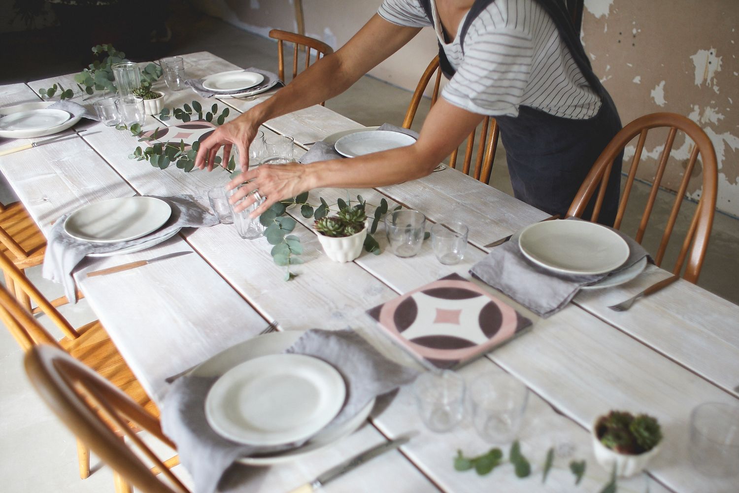 Hands adjusting a table setting in preparation for lifestyle branding shoot suffolk