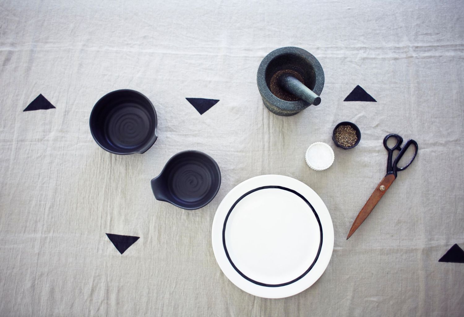 Monochrome cups and bowls and plates and scissors shot from above for lifestyle branding shoot Suffolk