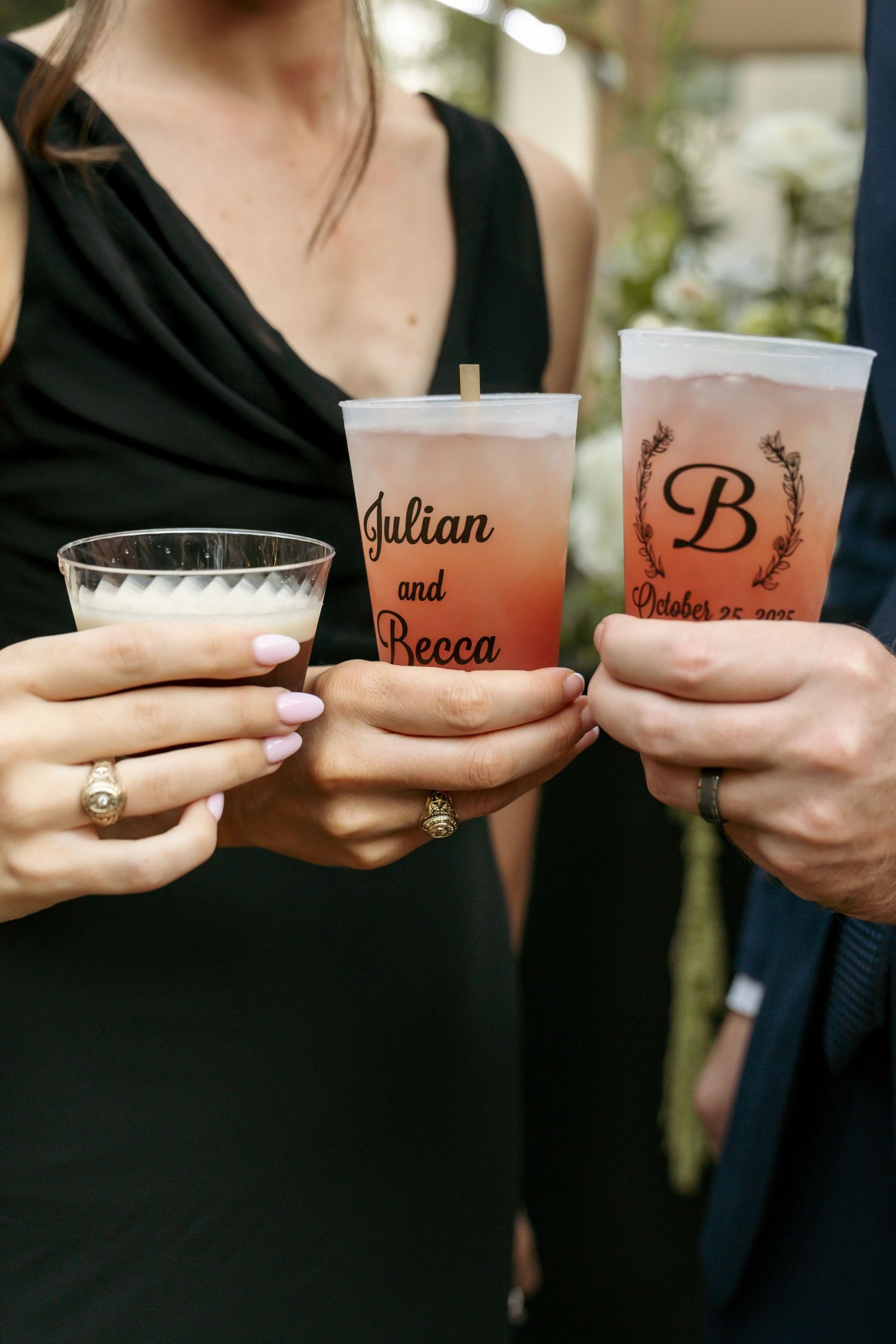 Guests hold custom frosted cups reading Julian and Becca with monogram B at an October wedding.