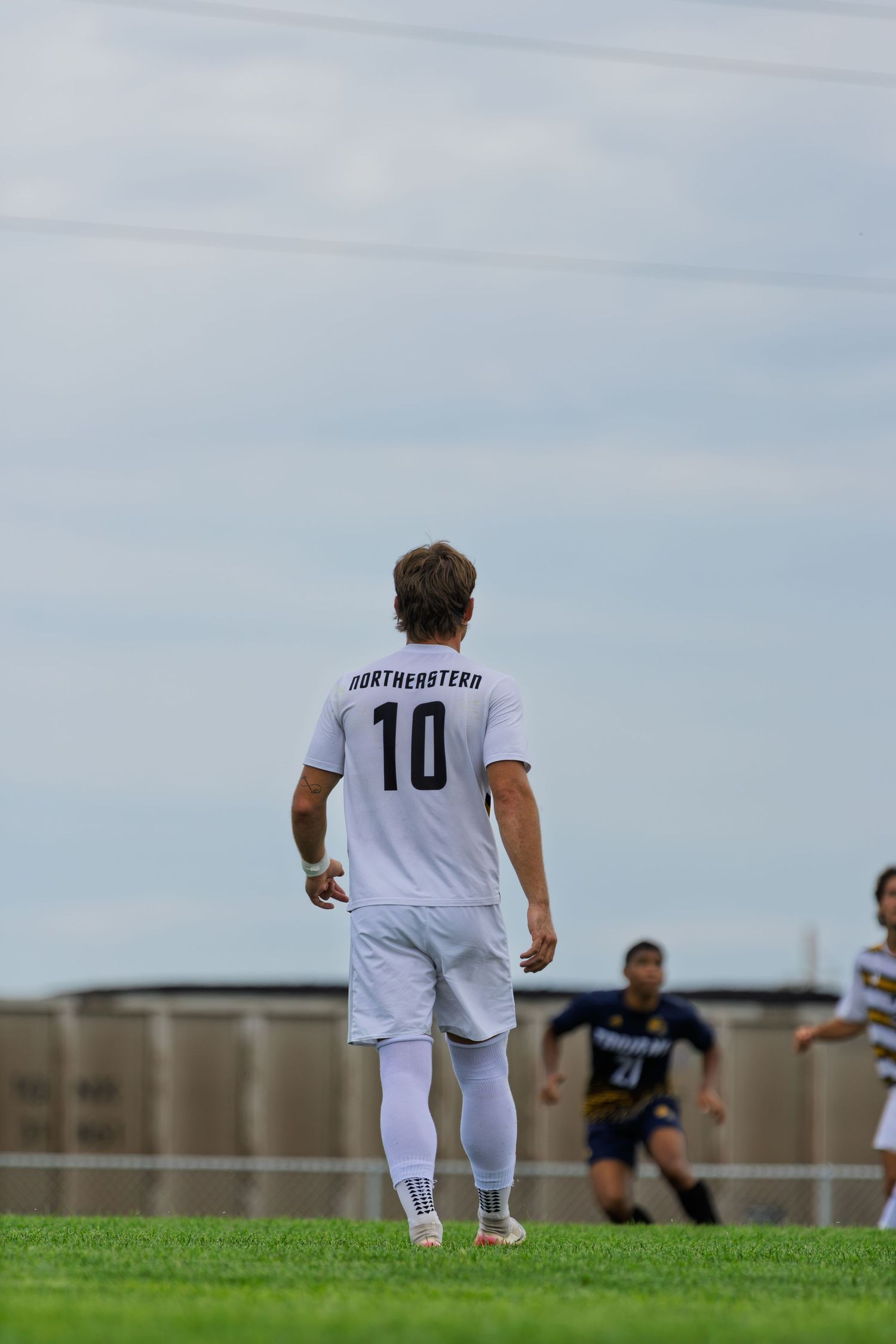 Northwestern number 10 soccer player walks on the field during a competitive college soccer match.