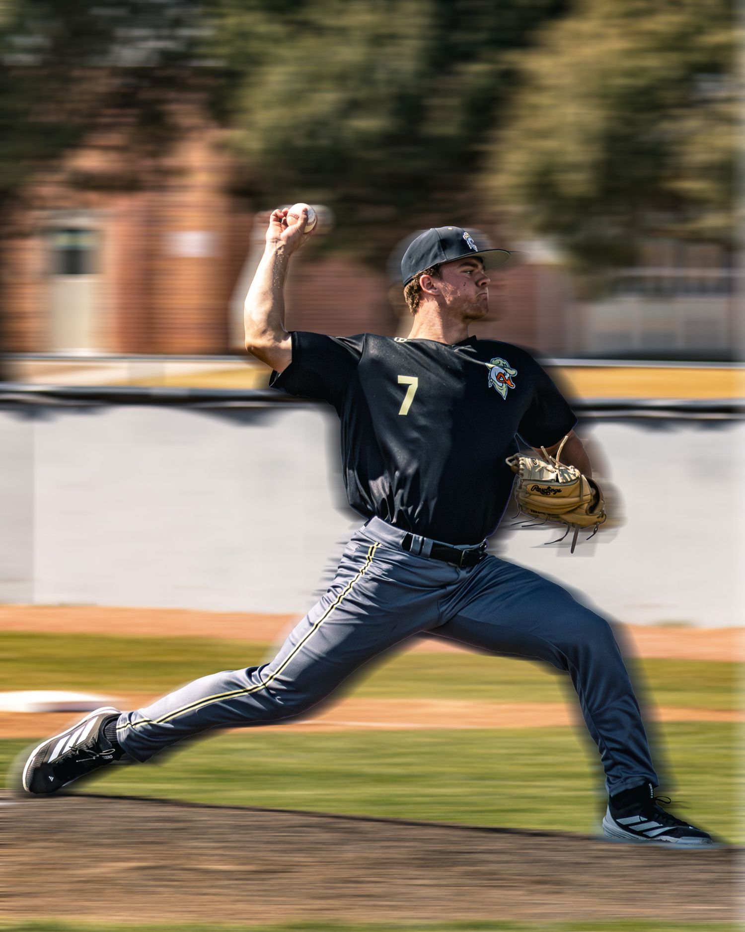 Pitcher #7 delivers pitch in motion-blurred action photo.