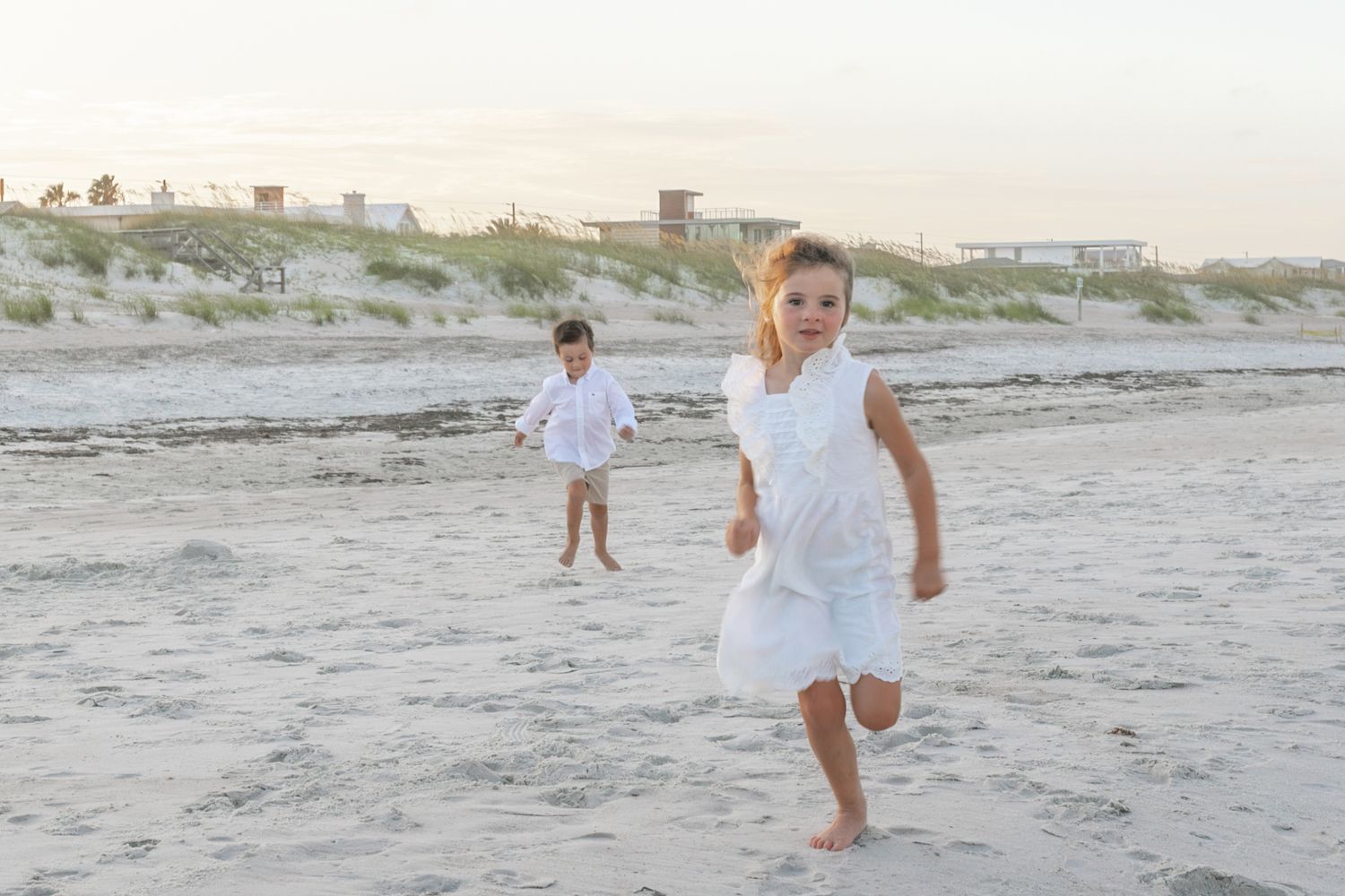 Boy and girl running on the beach on Amelia Island, Florida